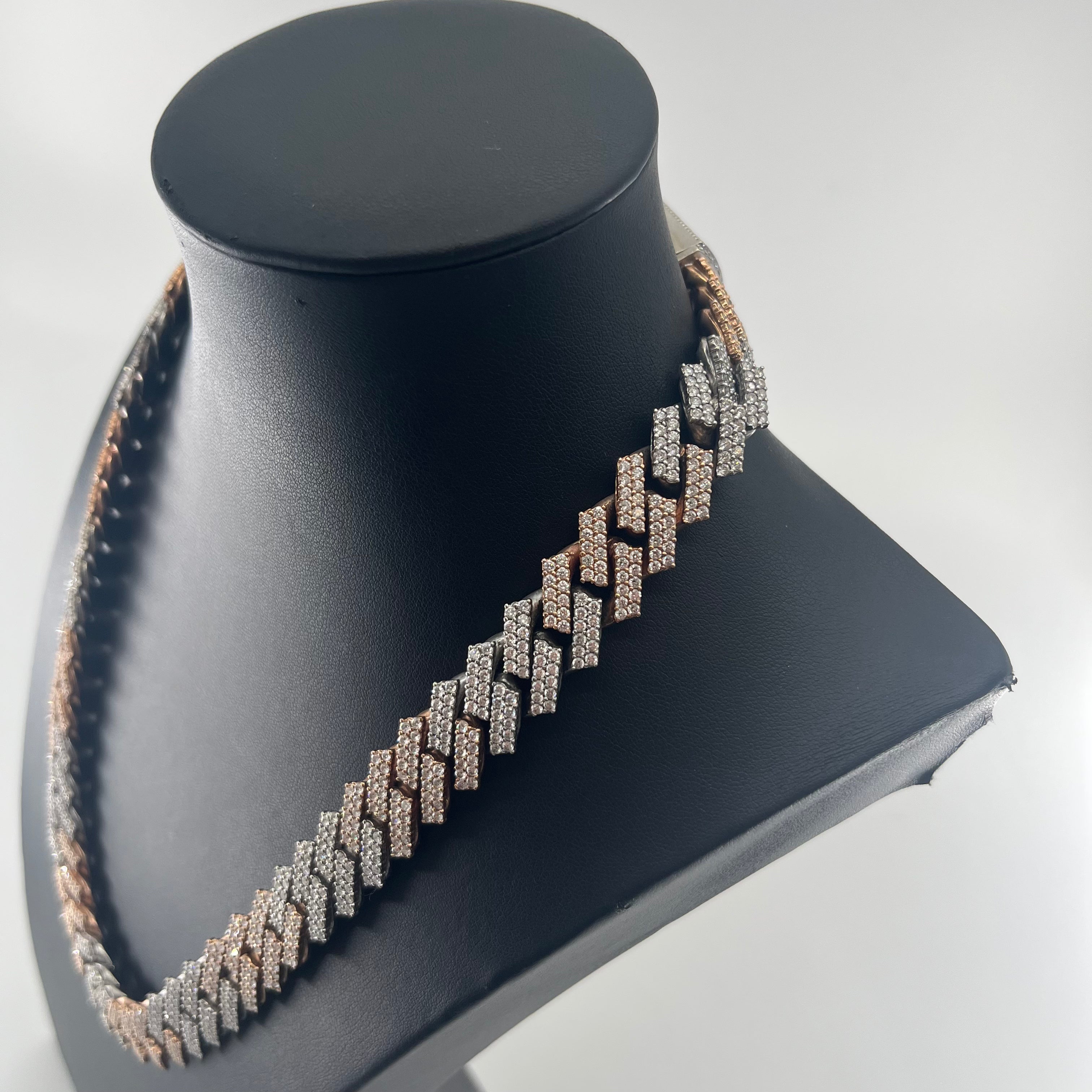 CB STORES chain with rose gold and silver zigzag links set with sparkling stones, shown on a black bust against a white background.