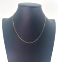 A CB STORES gold box chain necklace is displayed on a black jewellery bust against a plain white background.
