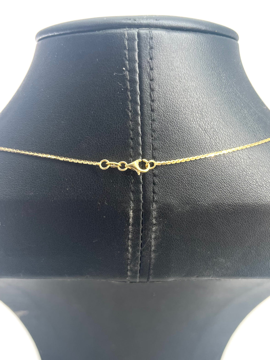 CB STORES gold box chain necklace displayed on a black stand, showing the fine links and a lobster clasp fastening.