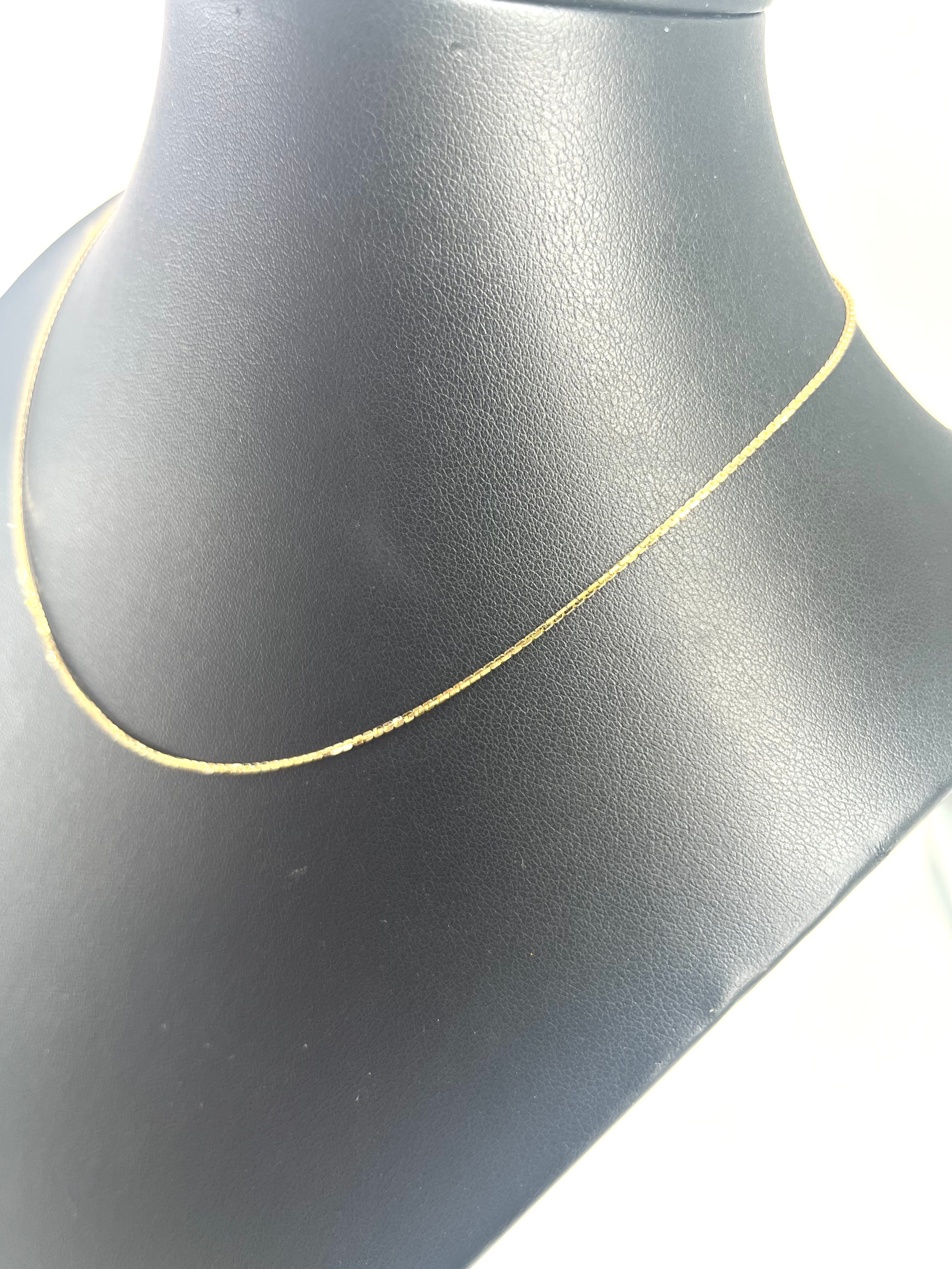 CB STORES gold box chain necklace displayed on a black jewellery bust with a white background.