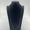 A yellow gold CB STORES 9ct anchor chain necklace displayed on a black mannequin bust against a plain white background.