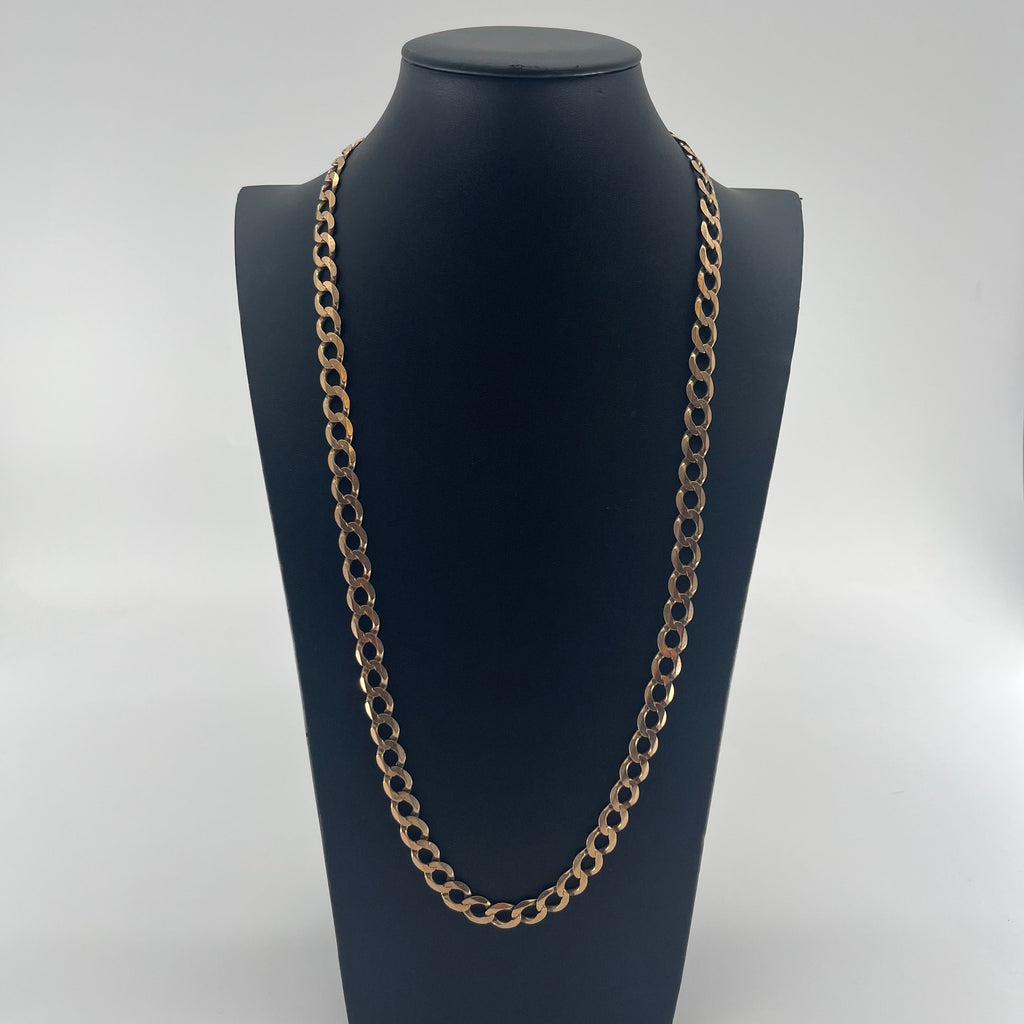 CB STORES yellow gold Figaro chain with oval links displayed on a black stand, set against a plain white background.