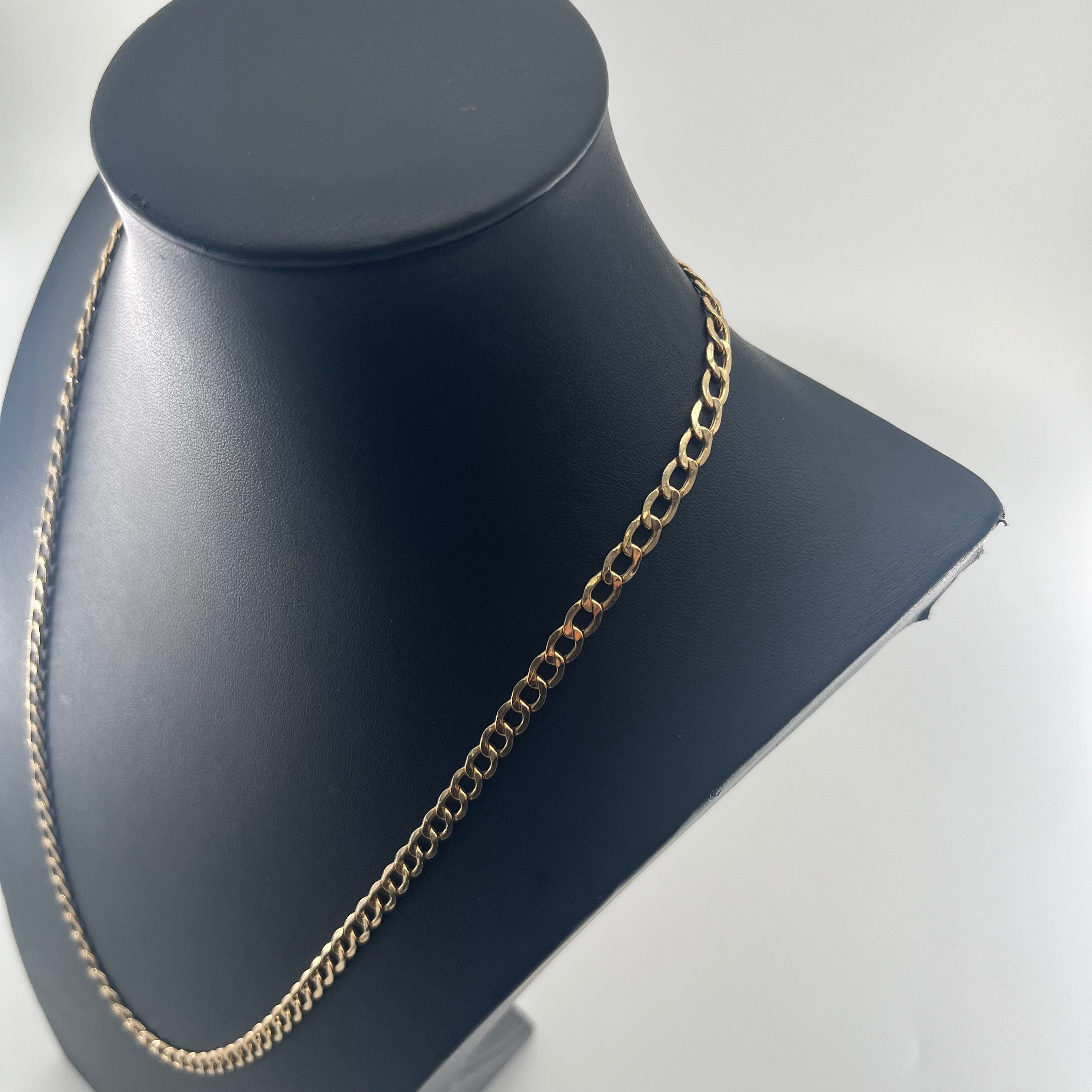 CB STORES 9ct flat curb chain displayed on a black angled jewellery bust with a plain white background.