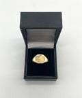 CB STORES 9ct square signet ring, partly engraved, displayed upright in a black ring box with white lining on a plain background.