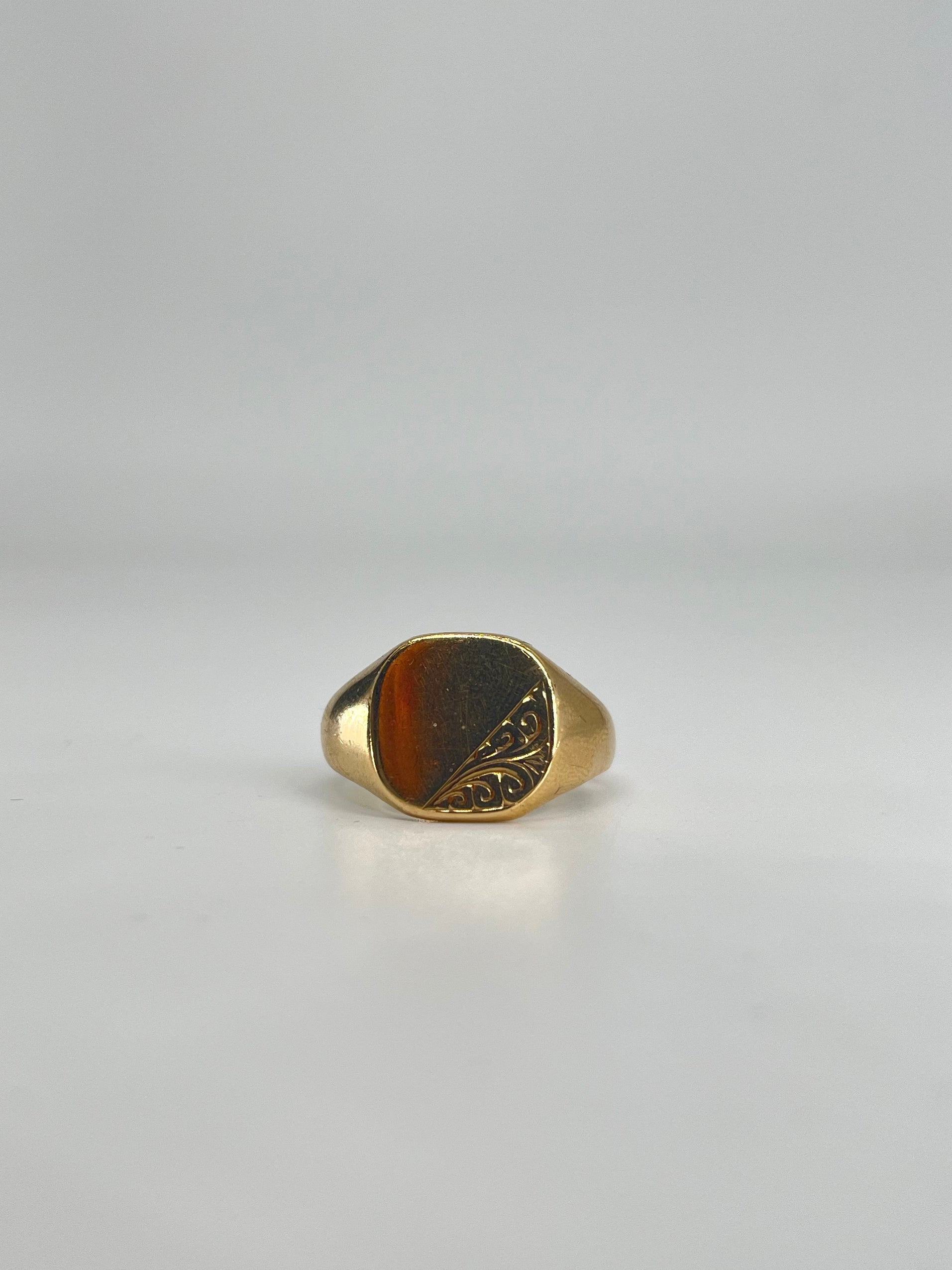 CB STORES 9ct gold square signet ring with a smooth face and engraved swirl detail on one side, displayed on a white background.