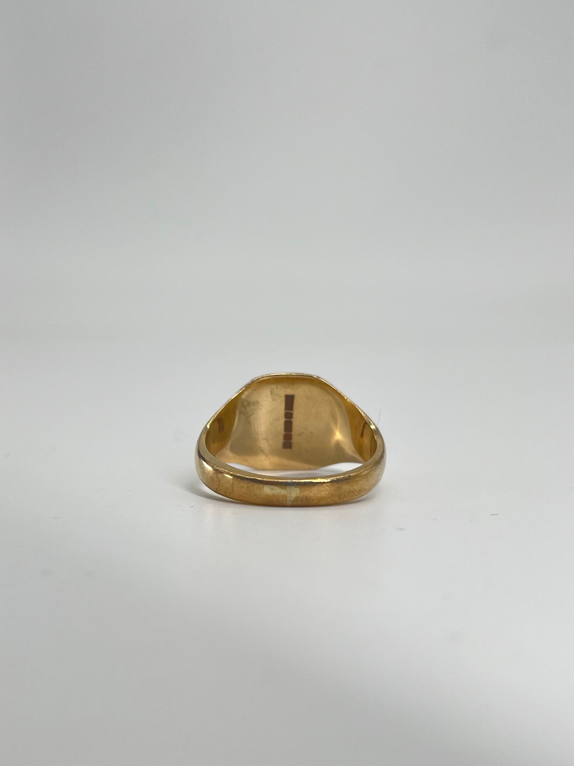 CB STORES 9ct gold square signet ring shown from a low angle on a white background, highlighting the polished inner band.