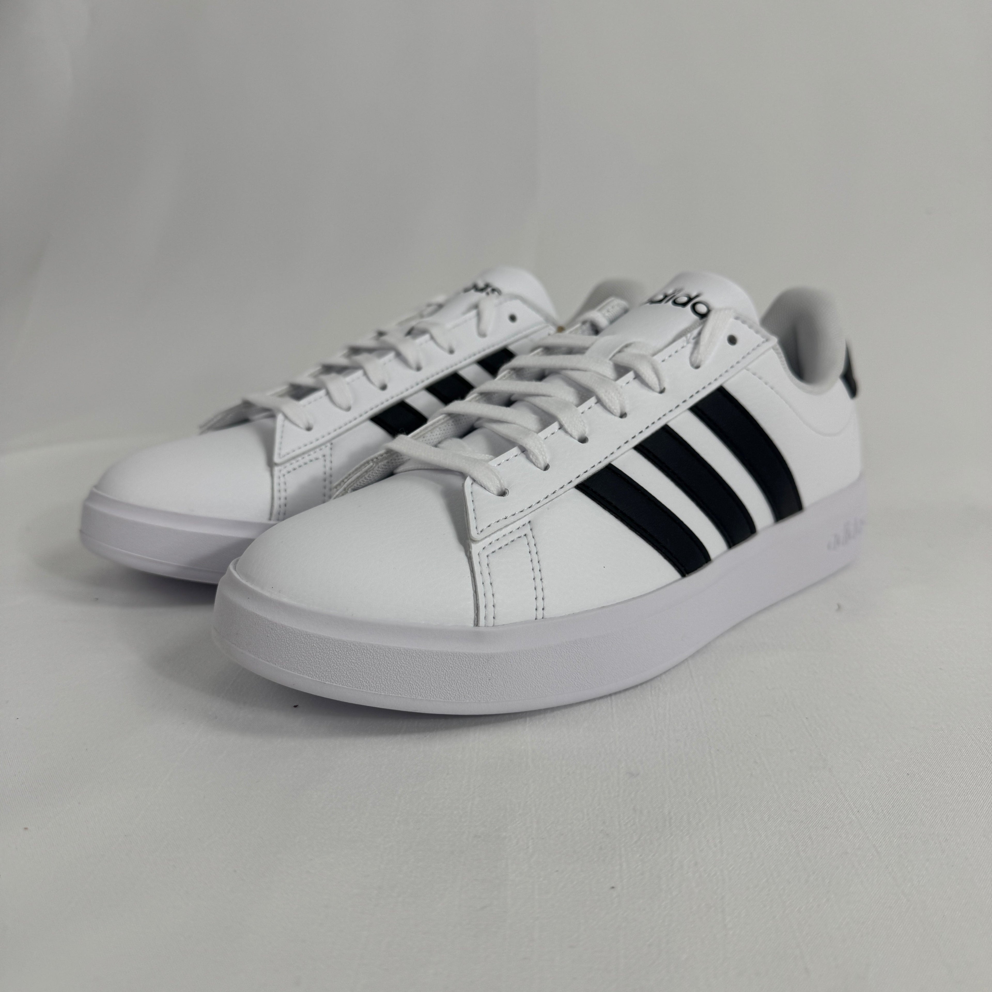 The Adidas Grand Court 2.0 is a casual court-inspired sneaker with a smooth synthetic or leather-like upper, soft