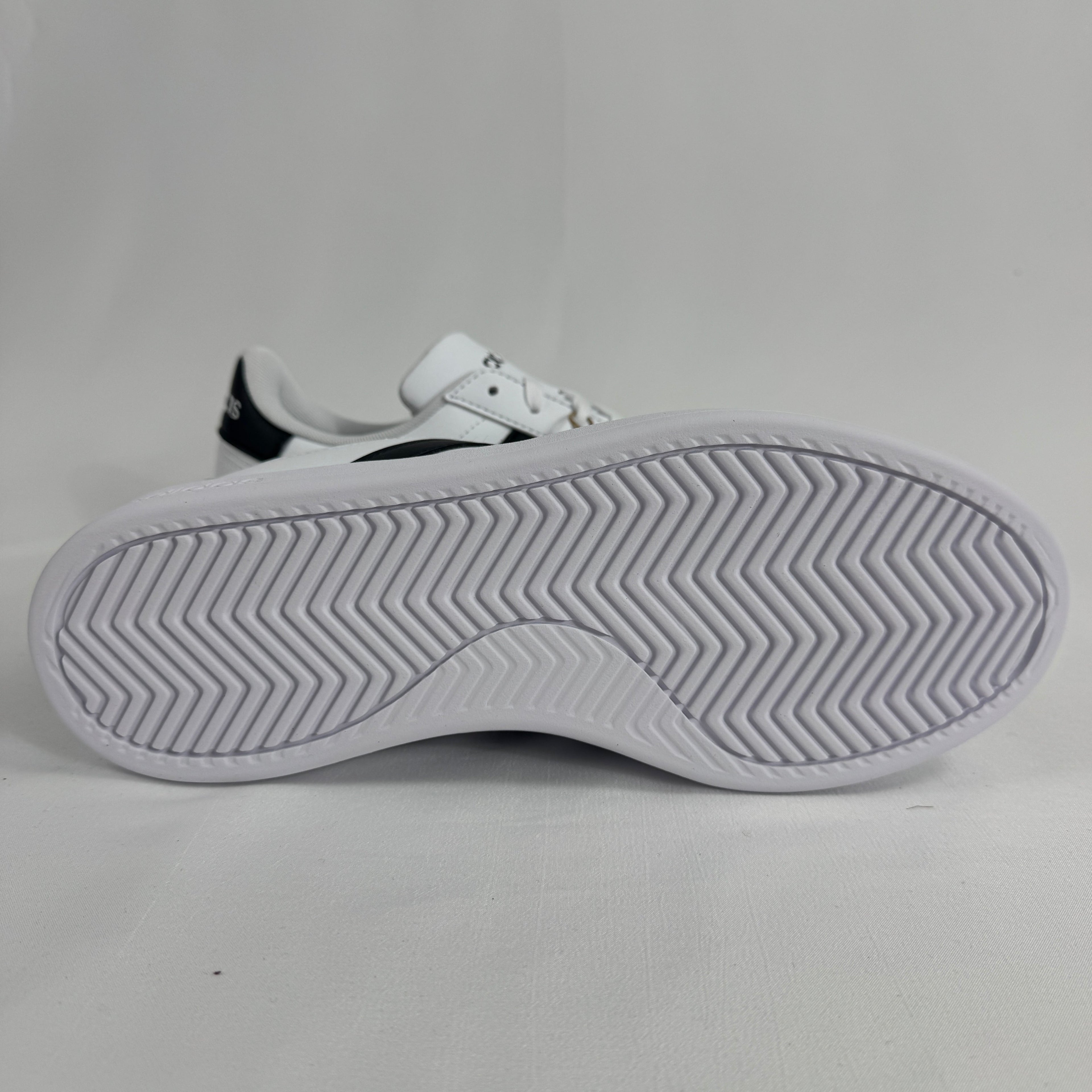 The Adidas Grand Court 2.0 is a casual court-inspired sneaker with a smooth synthetic or leather-like upper, soft