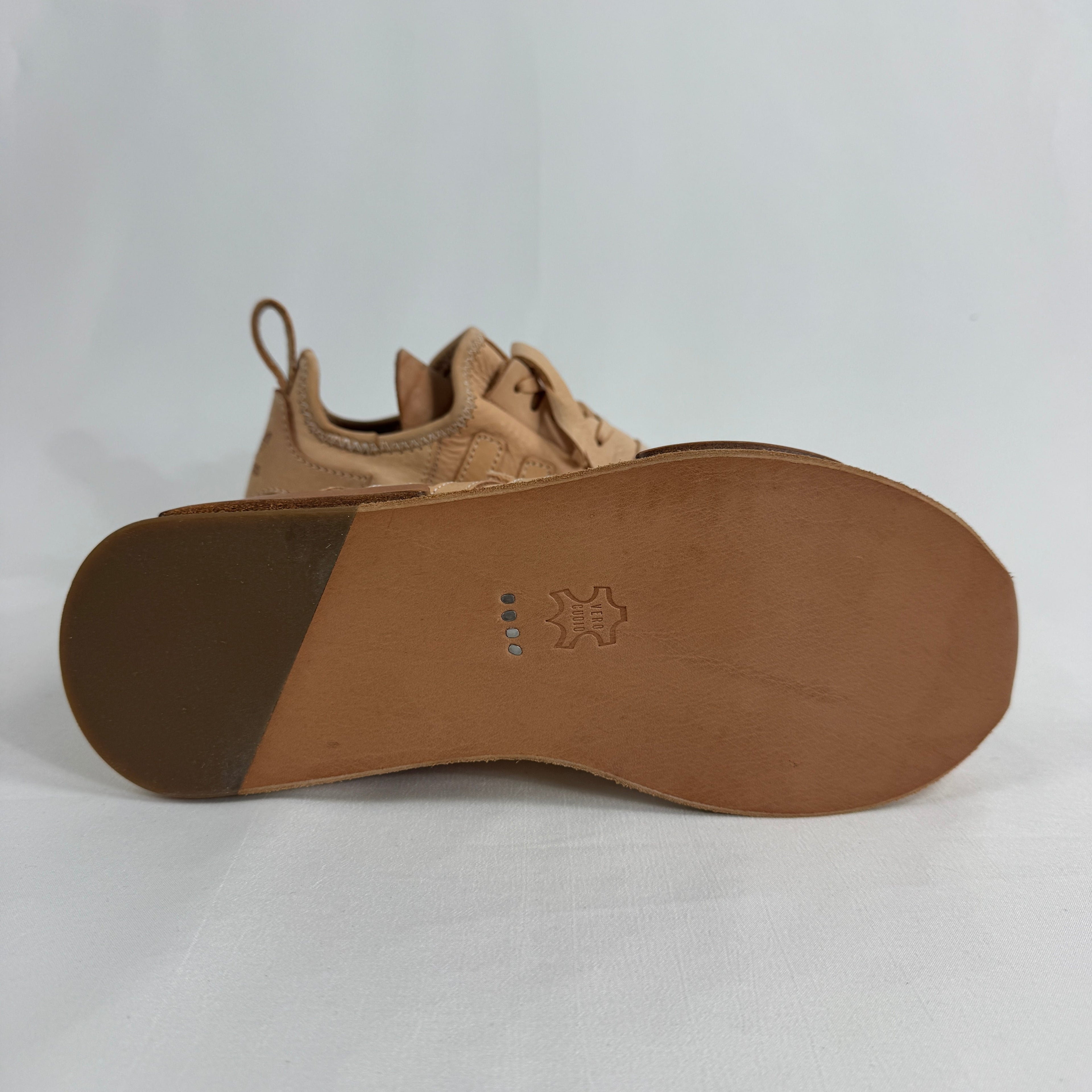 The Adidas x Hender Scheme NMD R1 is a premium collaboration that reimagines the iconic NMD with handcrafted natural leather