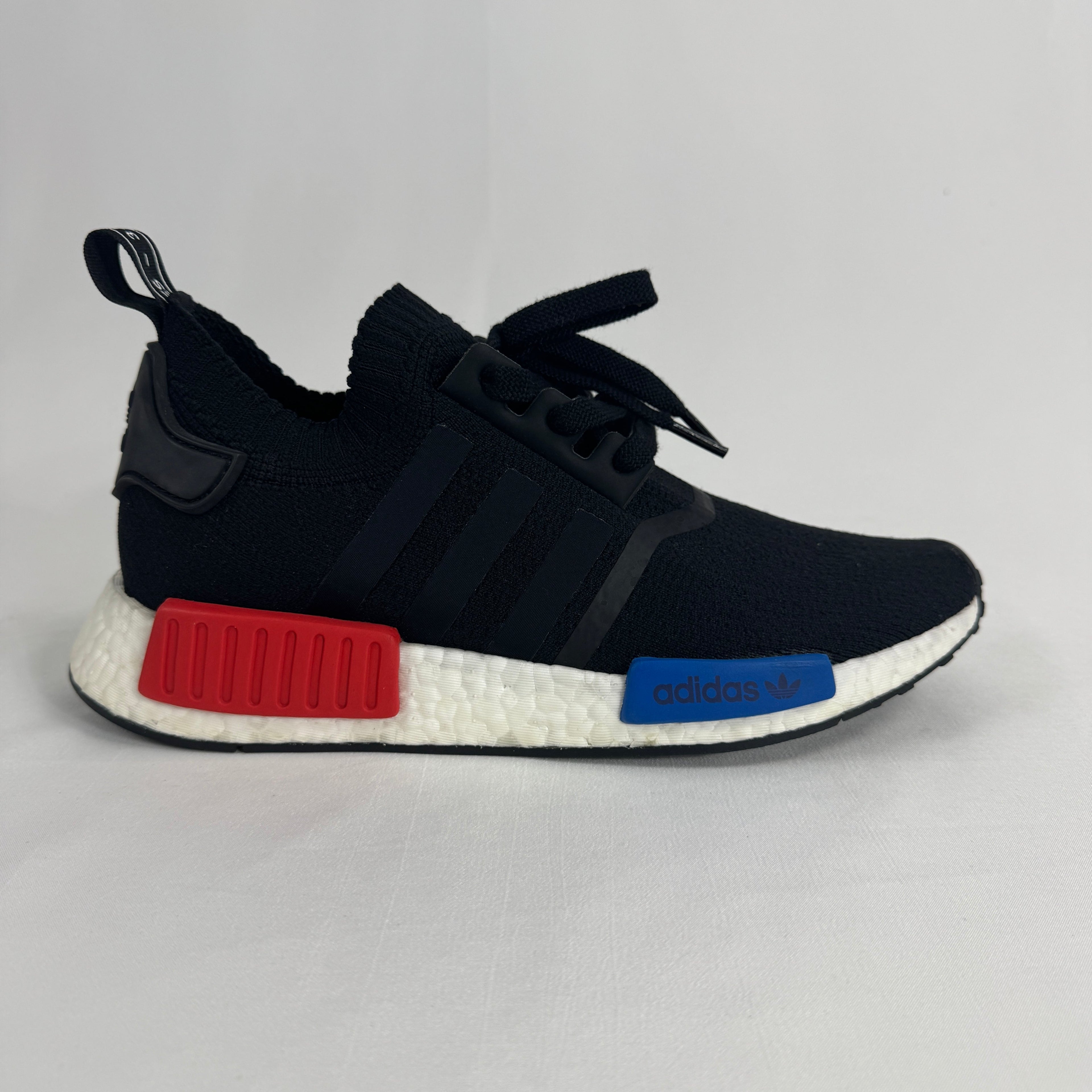 The Adidas NMD R1 Core Black is a lifestyle sneaker that combines a breathable knit upper with responsive Boost cushioning