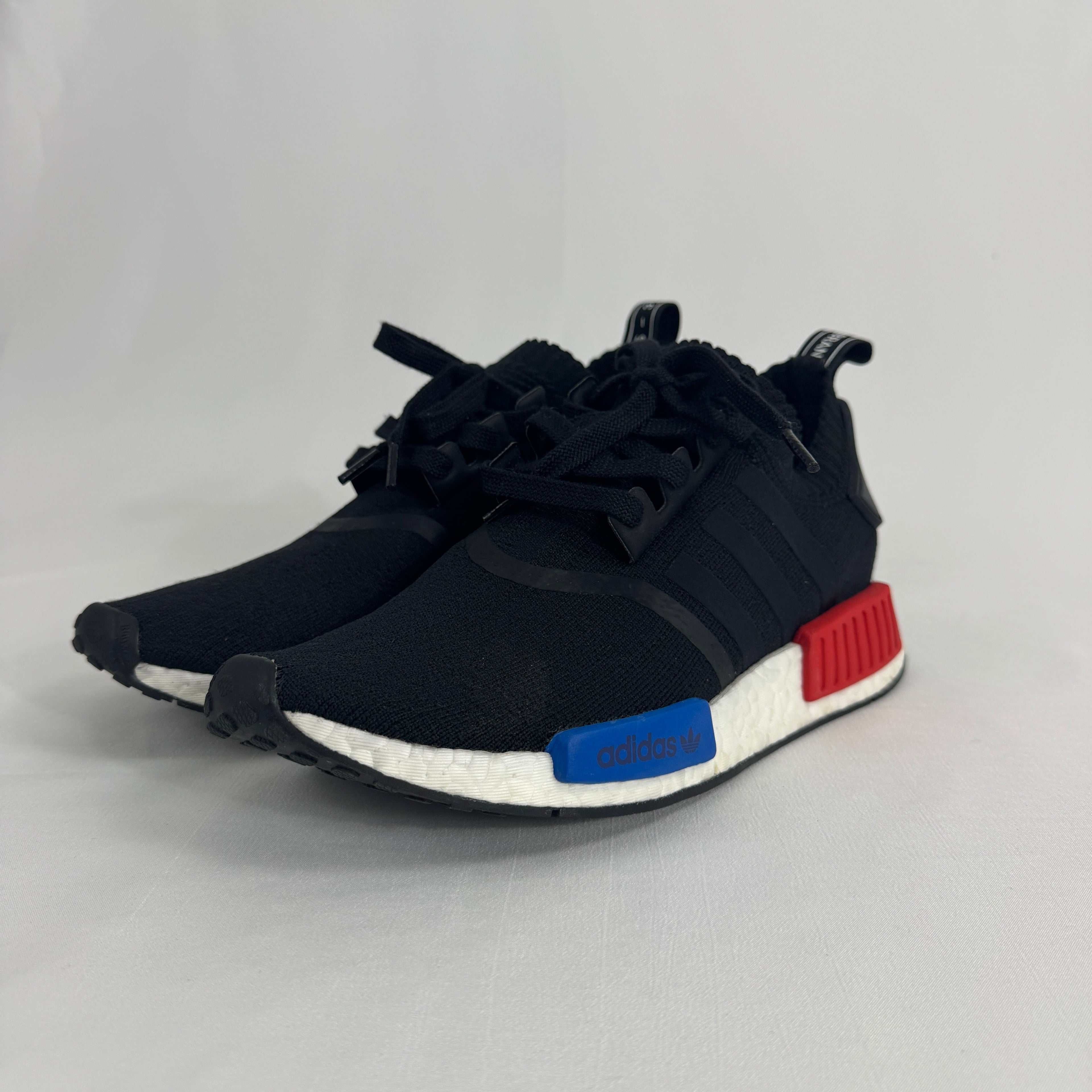 The Adidas NMD R1 Core Black is a lifestyle sneaker that combines a breathable knit upper with responsive Boost cushioning
