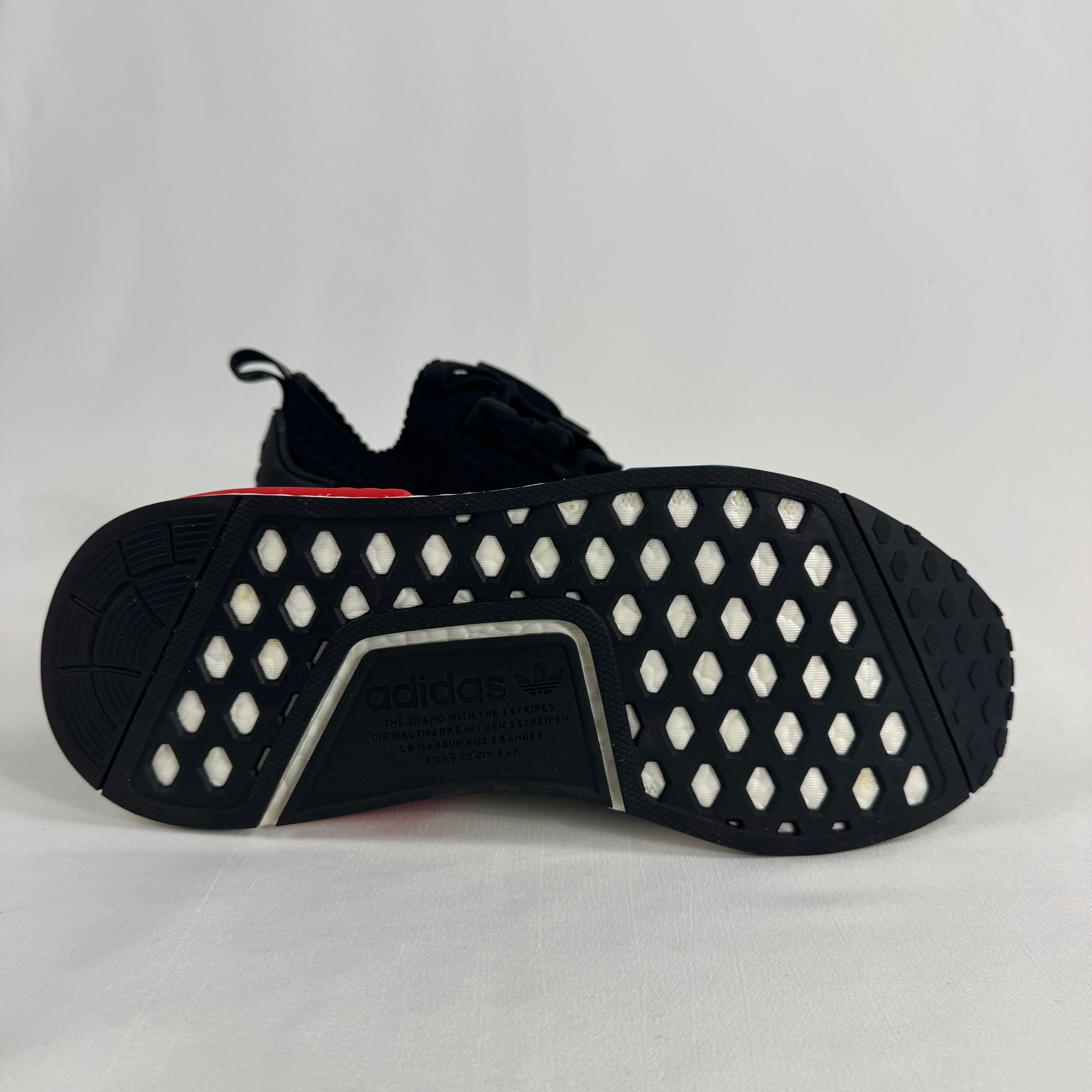 The Adidas NMD R1 Core Black is a lifestyle sneaker that combines a breathable knit upper with responsive Boost cushioning