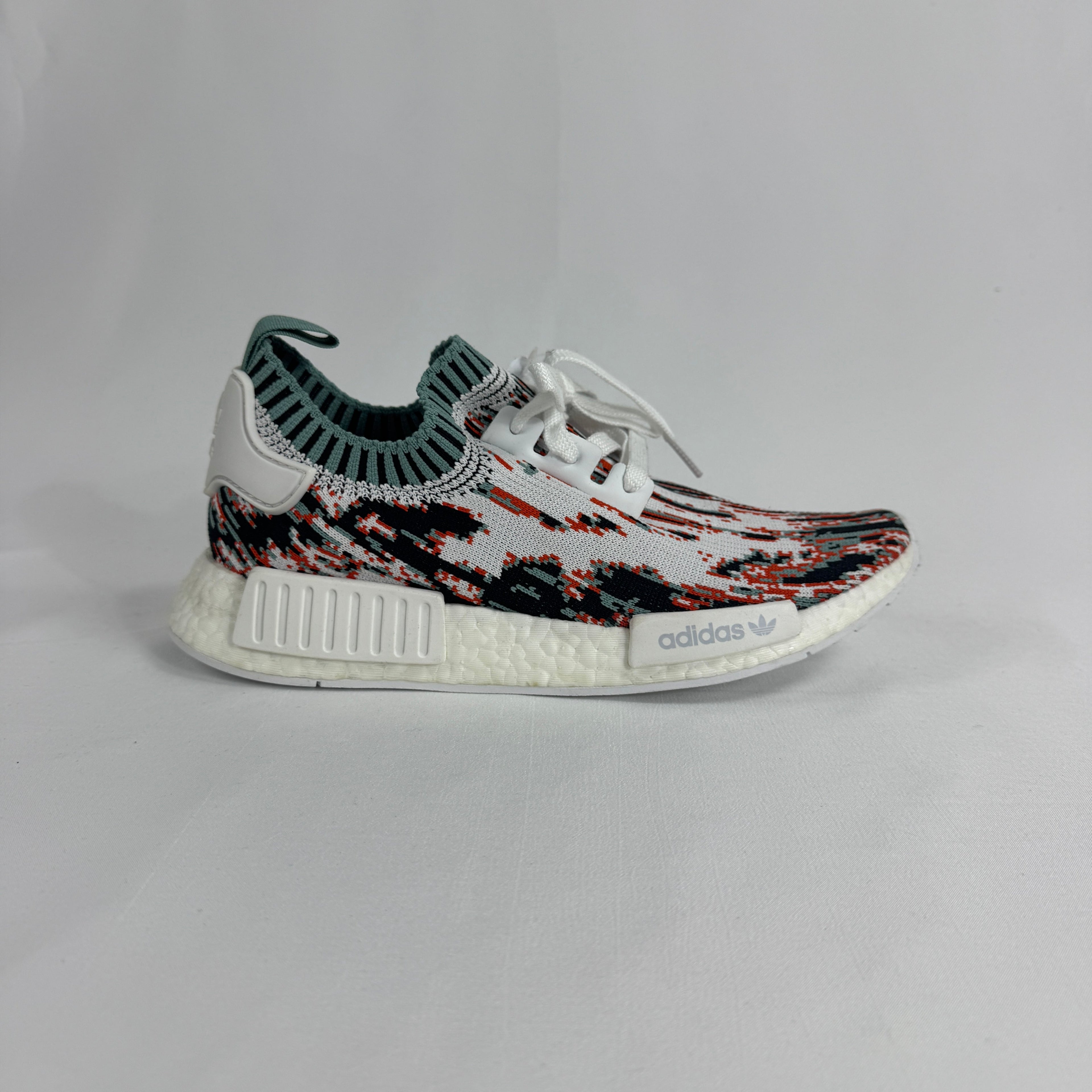 The Adidas NMD R1 Datamosh Collegiate is a lifestyle sneaker featuring a breathable knit upper with digitally inspired