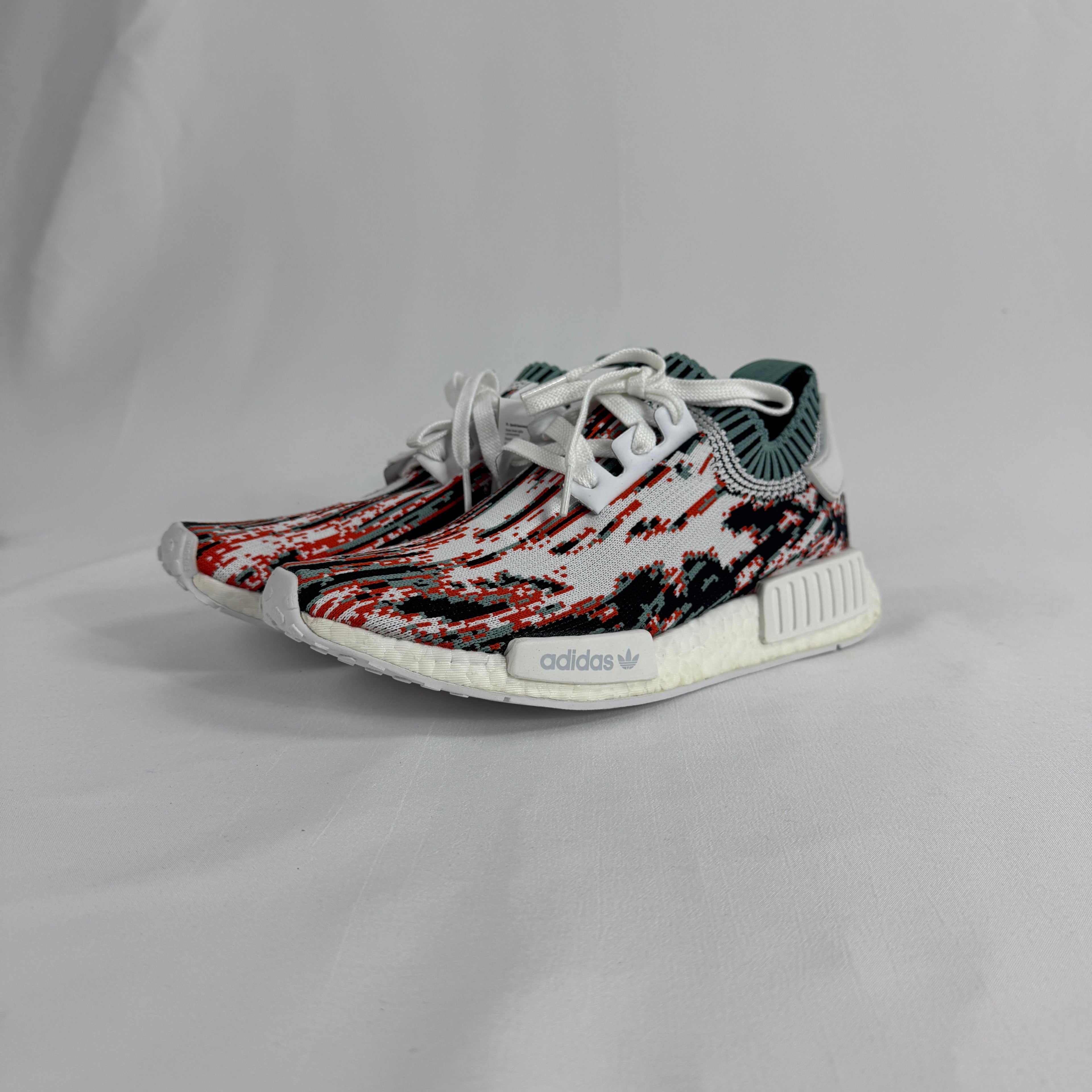 The Adidas NMD R1 Datamosh Collegiate is a lifestyle sneaker featuring a breathable knit upper with digitally inspired