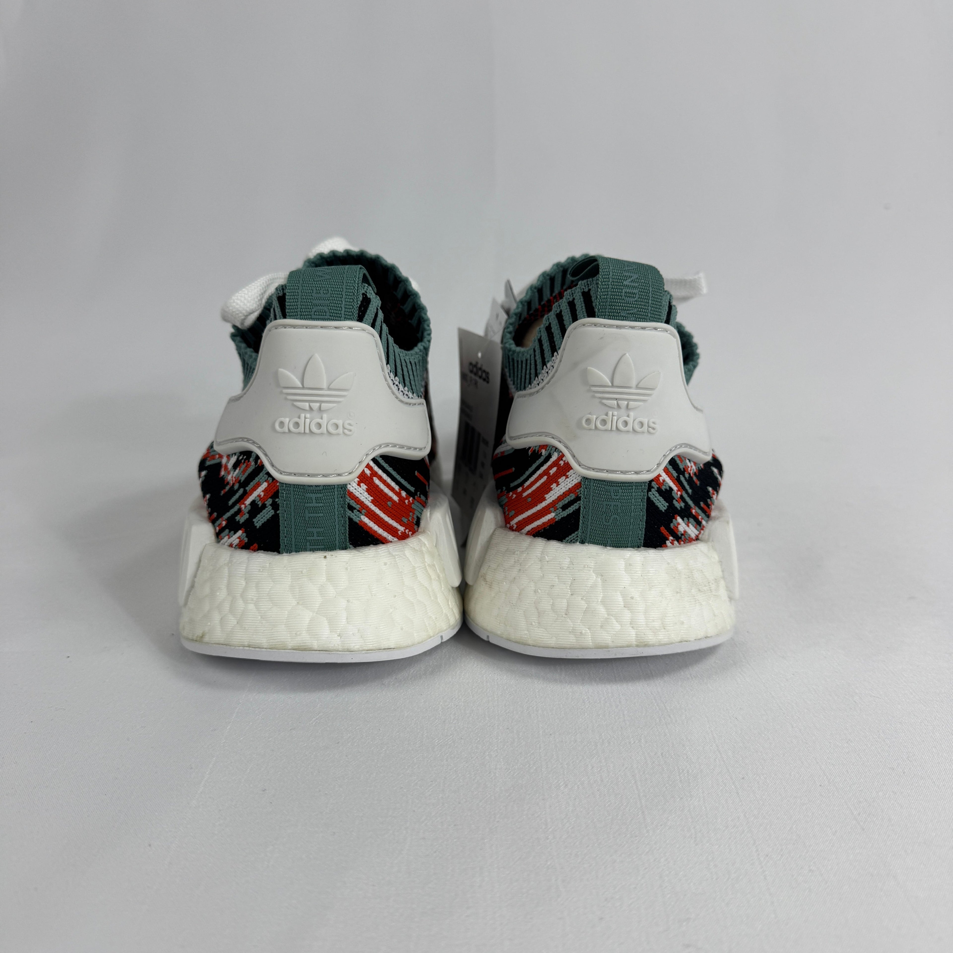The Adidas NMD R1 Datamosh Collegiate is a lifestyle sneaker featuring a breathable knit upper with digitally inspired