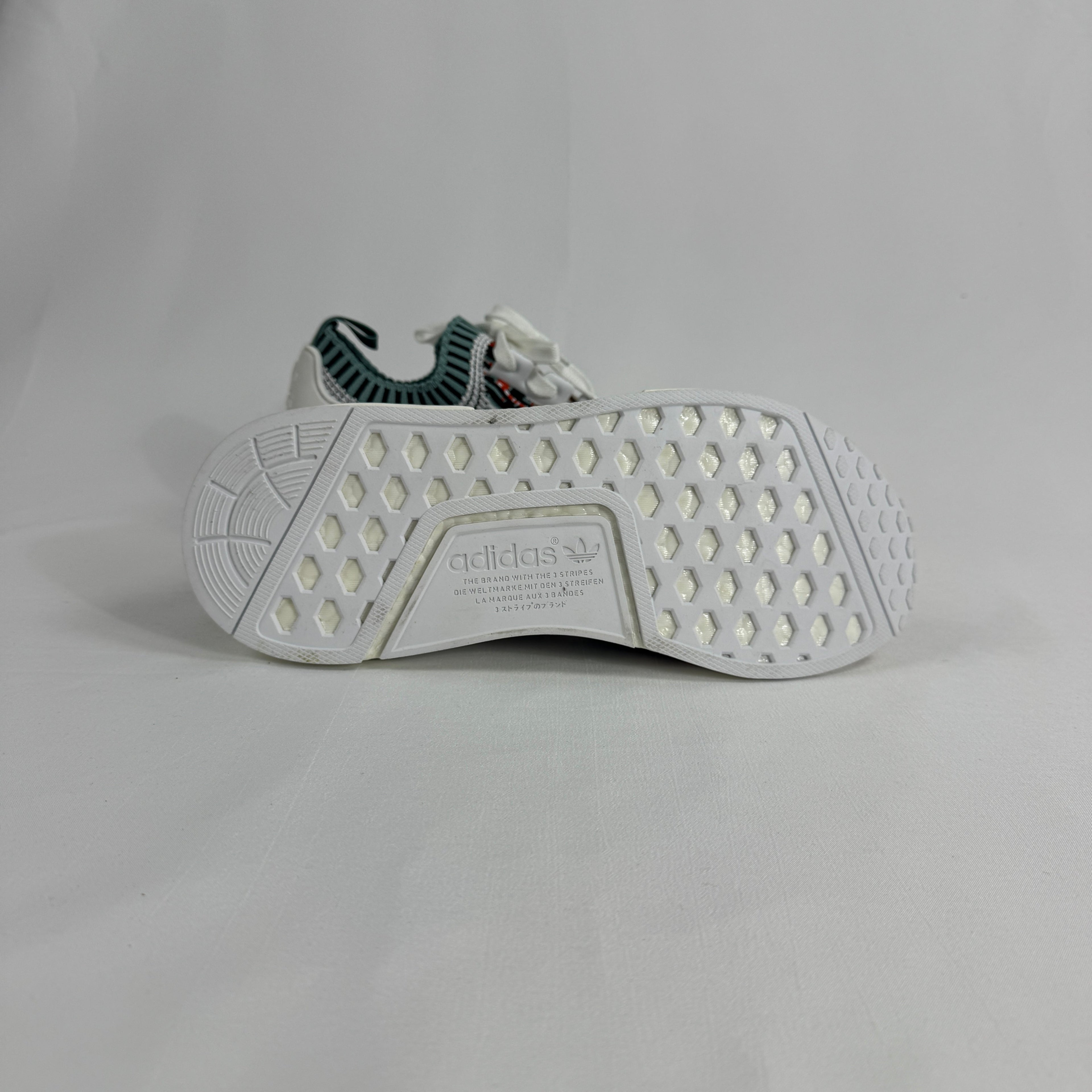 The Adidas NMD R1 Datamosh Collegiate is a lifestyle sneaker featuring a breathable knit upper with digitally inspired