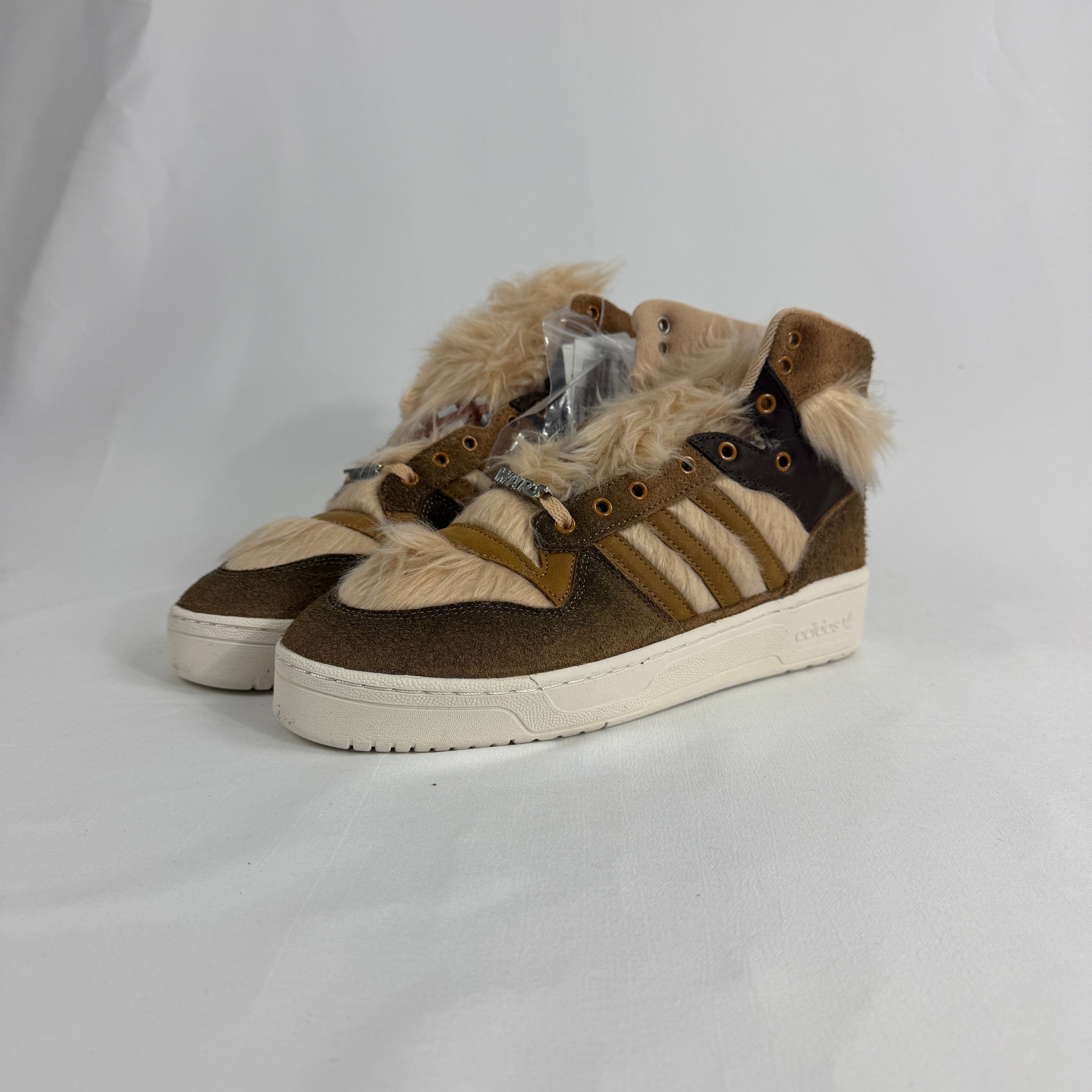 The Adidas Rivalry Hi Star Wars Chewbacca is a high-top sneaker inspired by the iconic Star Wars character, featuring