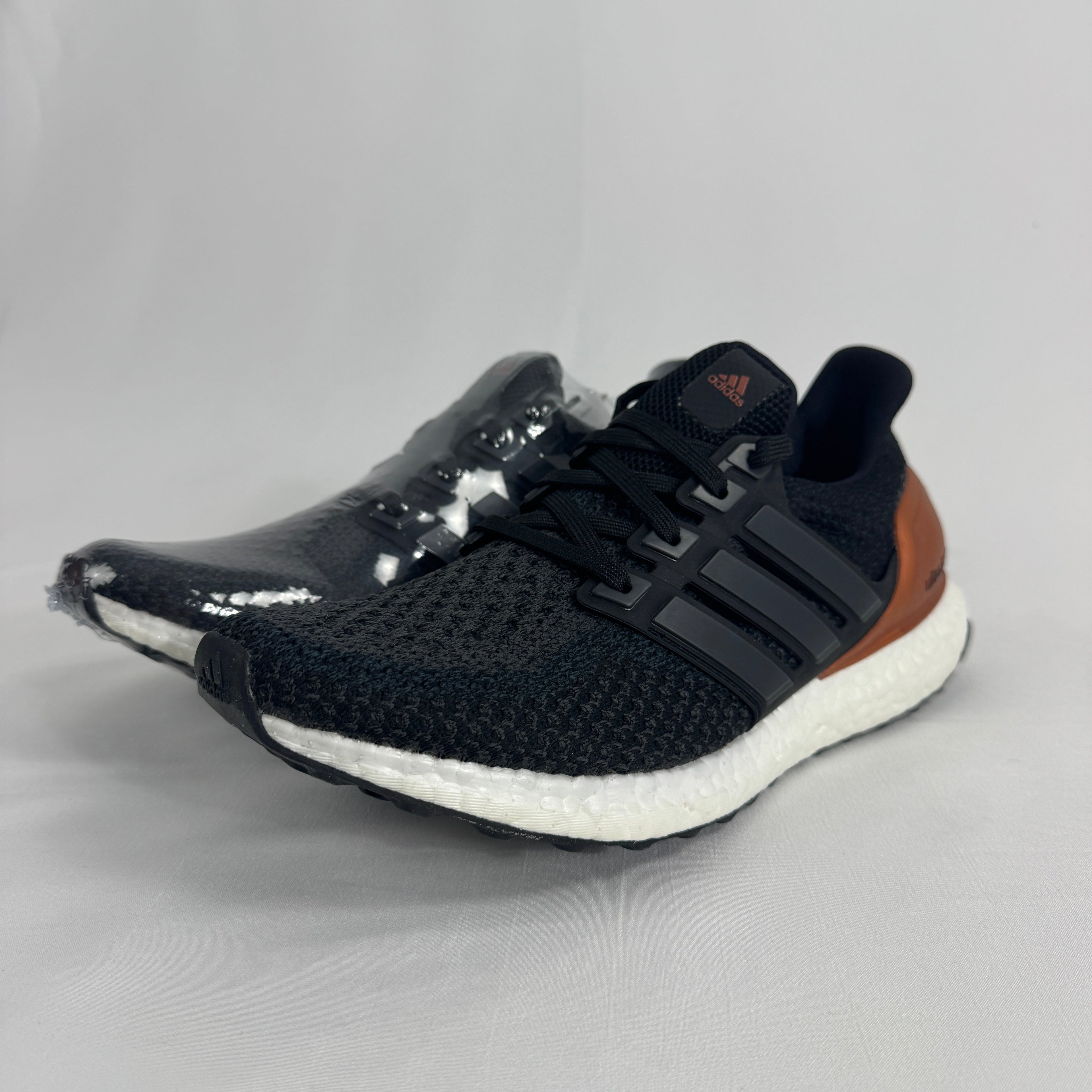 The Adidas Ultra Boost Bronze is a performance-inspired sneaker featuring a breathable Primeknit upper, responsive Boost