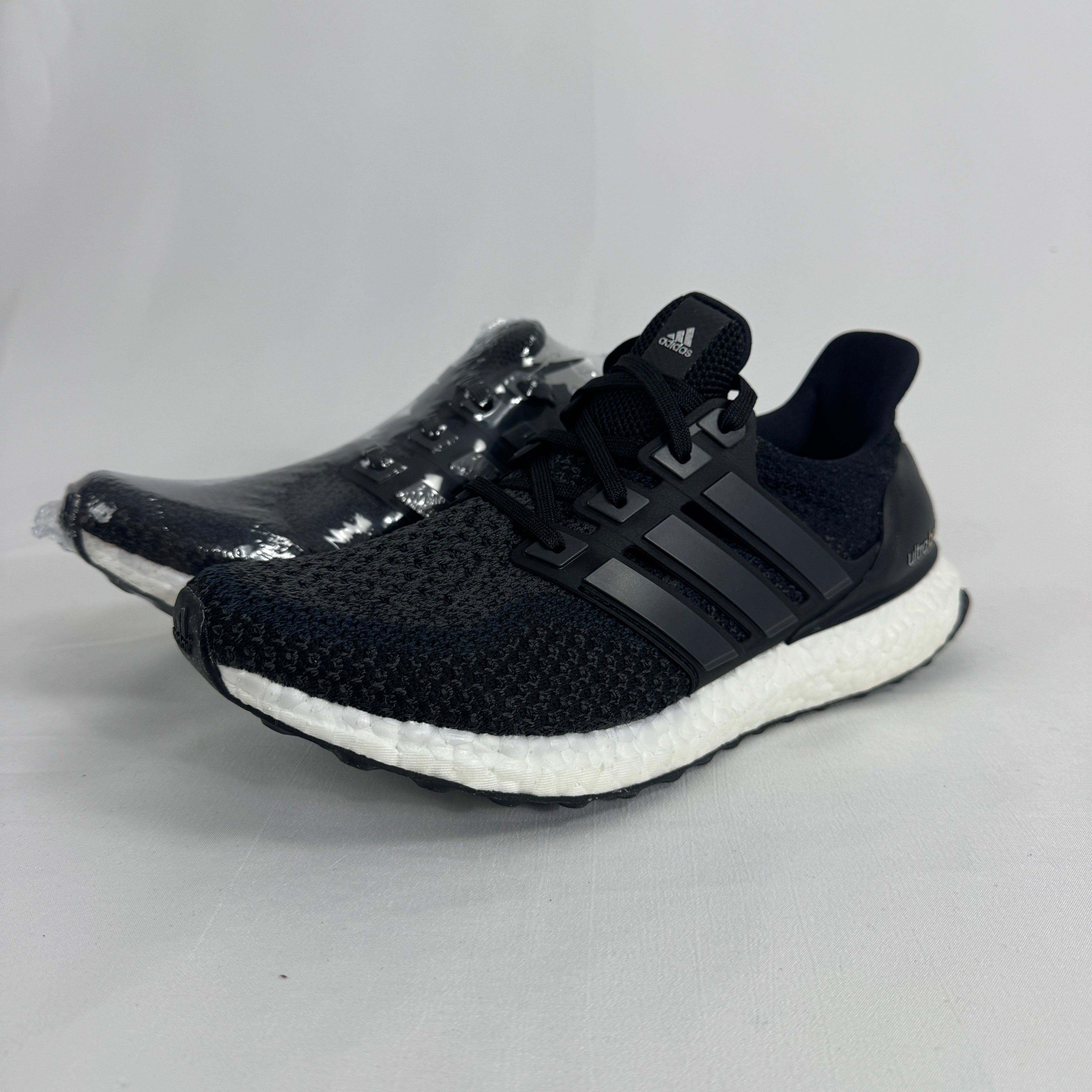 The Adidas Ultraboost 2.0 Core Black White is a running-inspired sneaker featuring a breathable Primeknit upper, responsive