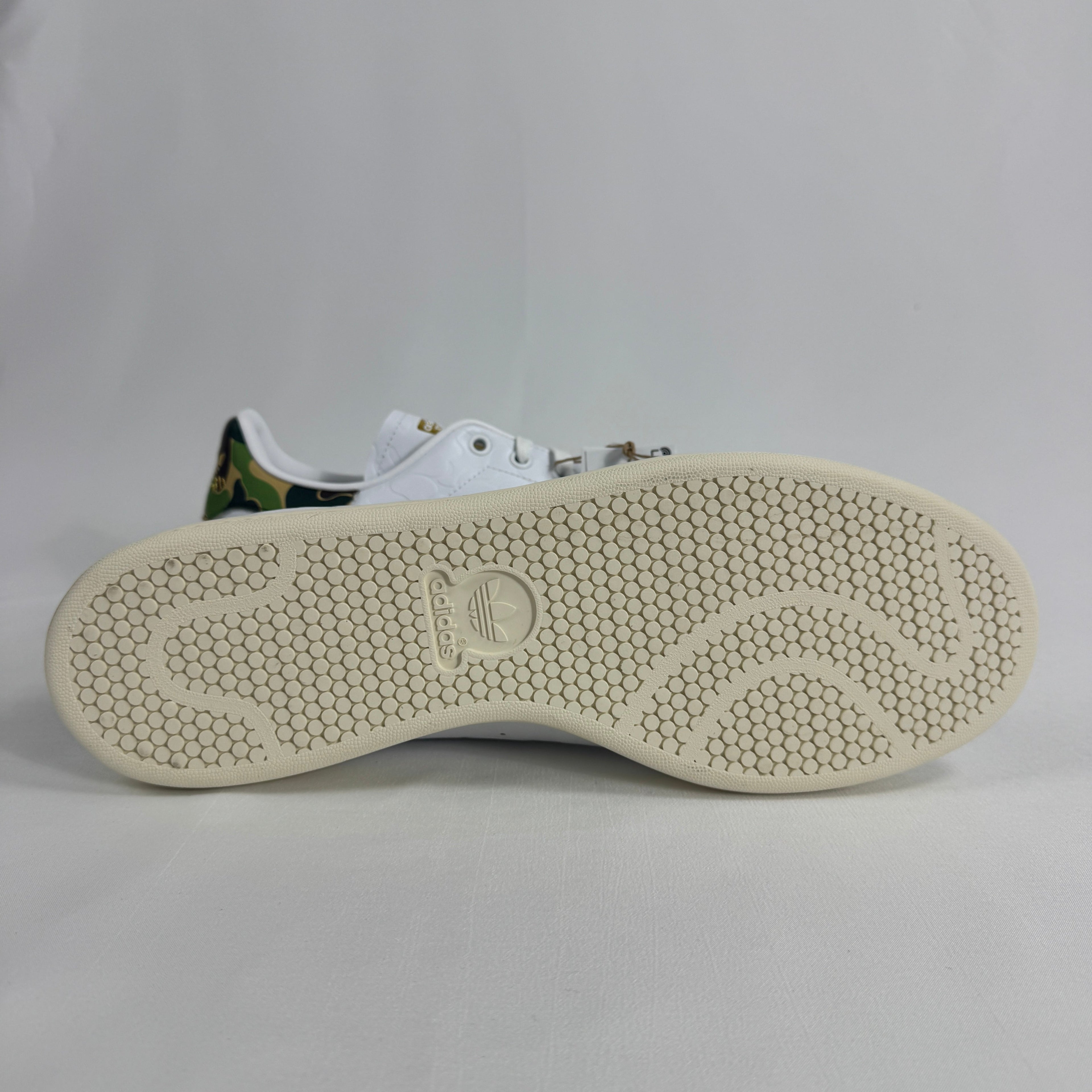 The Adidas x Bape Stan Smith is a collaborative sneaker that blends the classic Stan Smith silhouette with BAPE's signature