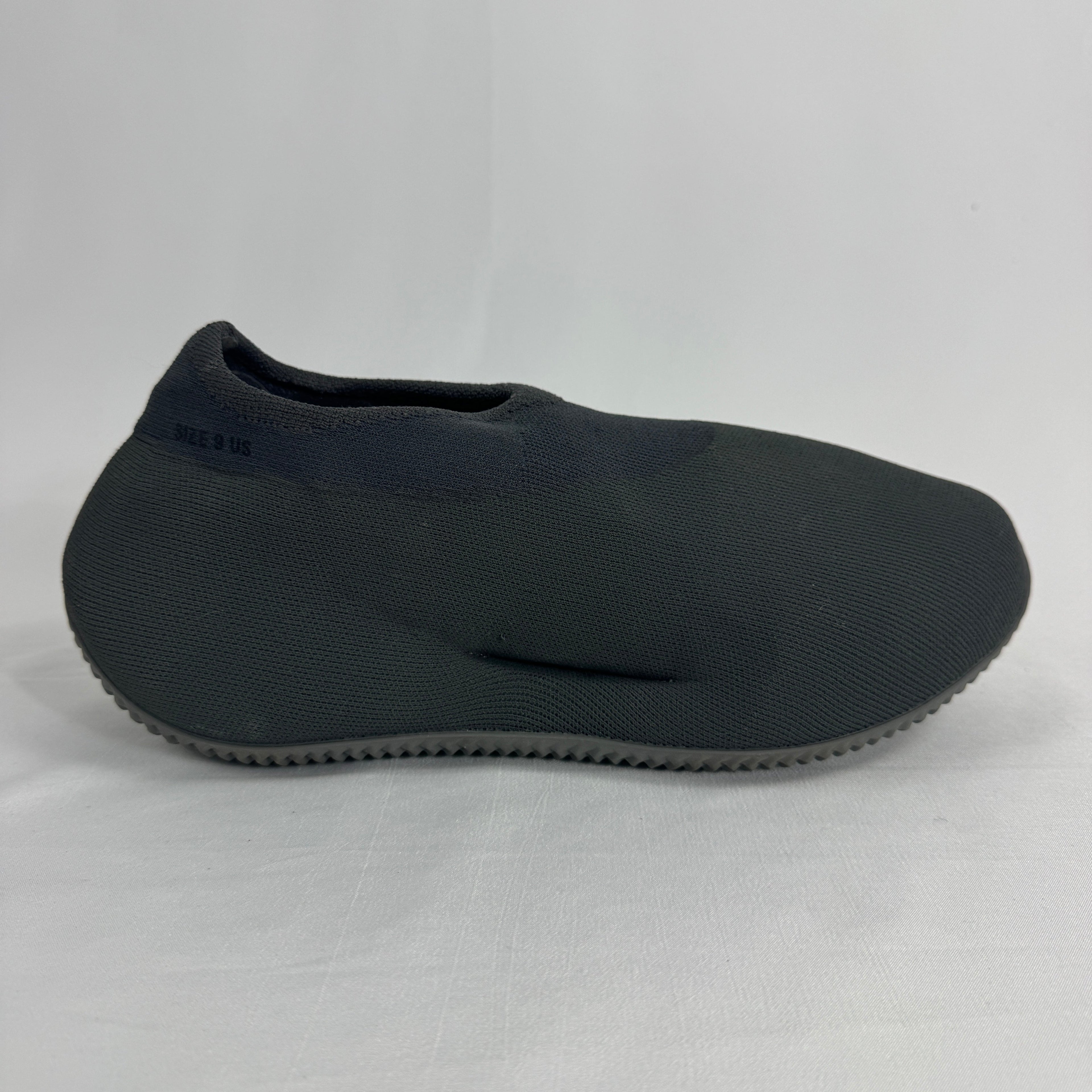 The Adidas Yeezy Knit RNR is a slip-on sneaker featuring a fully knitted one-piece upper with a sock-like fit and a sculpted