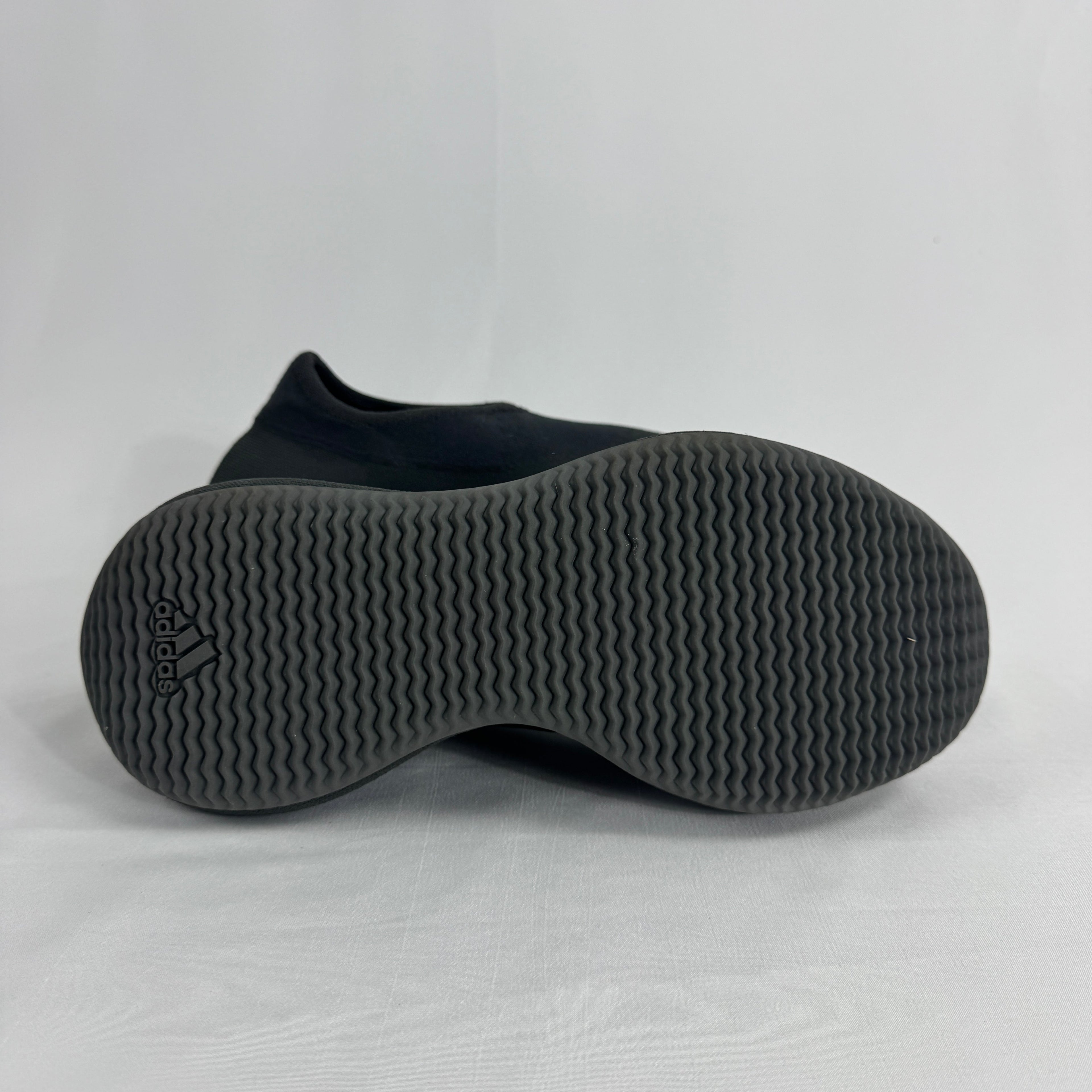 The Adidas Yeezy Knit RNR is a slip-on sneaker featuring a fully knitted one-piece upper with a sock-like fit and a sculpted