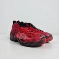 Nike trainers with a glossy red and black wavy pattern and black laces, shown against a plain white background.