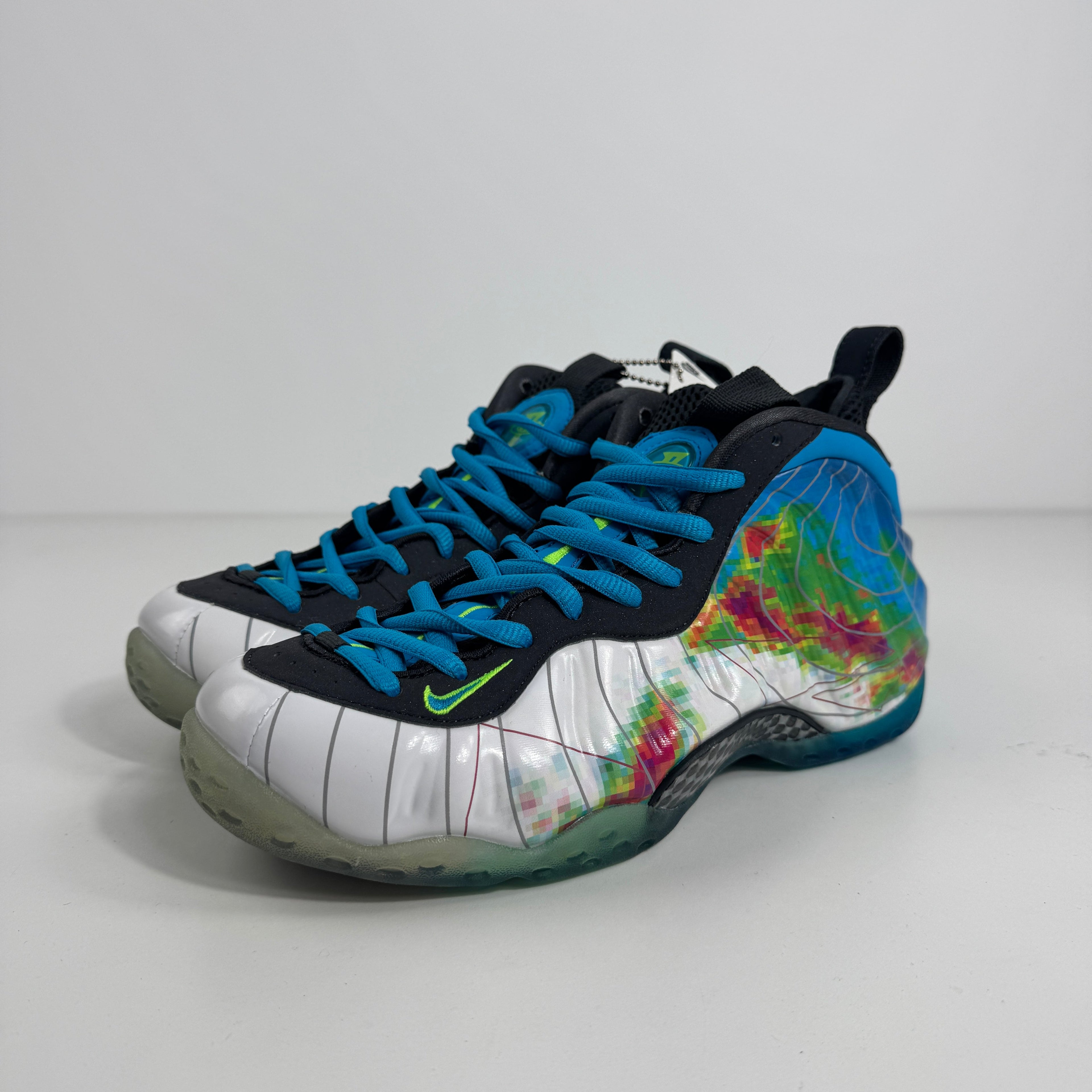 Nike Air Foamposite One trainer with blue laces, a white and blue upper, colourful side patterns, black accents and translucent soles.
