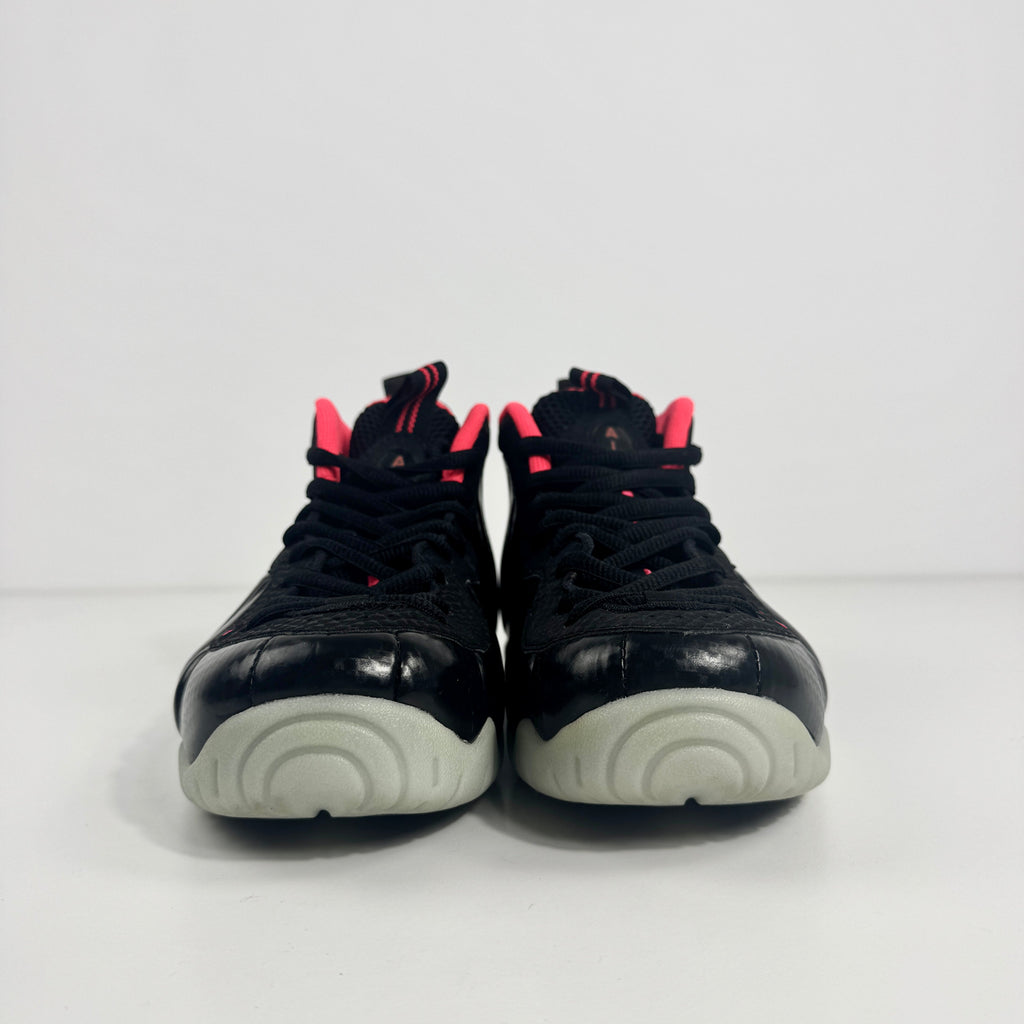 Nike Air Foamposite Pro sneakers with black moulded uppers, red detailing and light grey soles, shown side by side on white background.