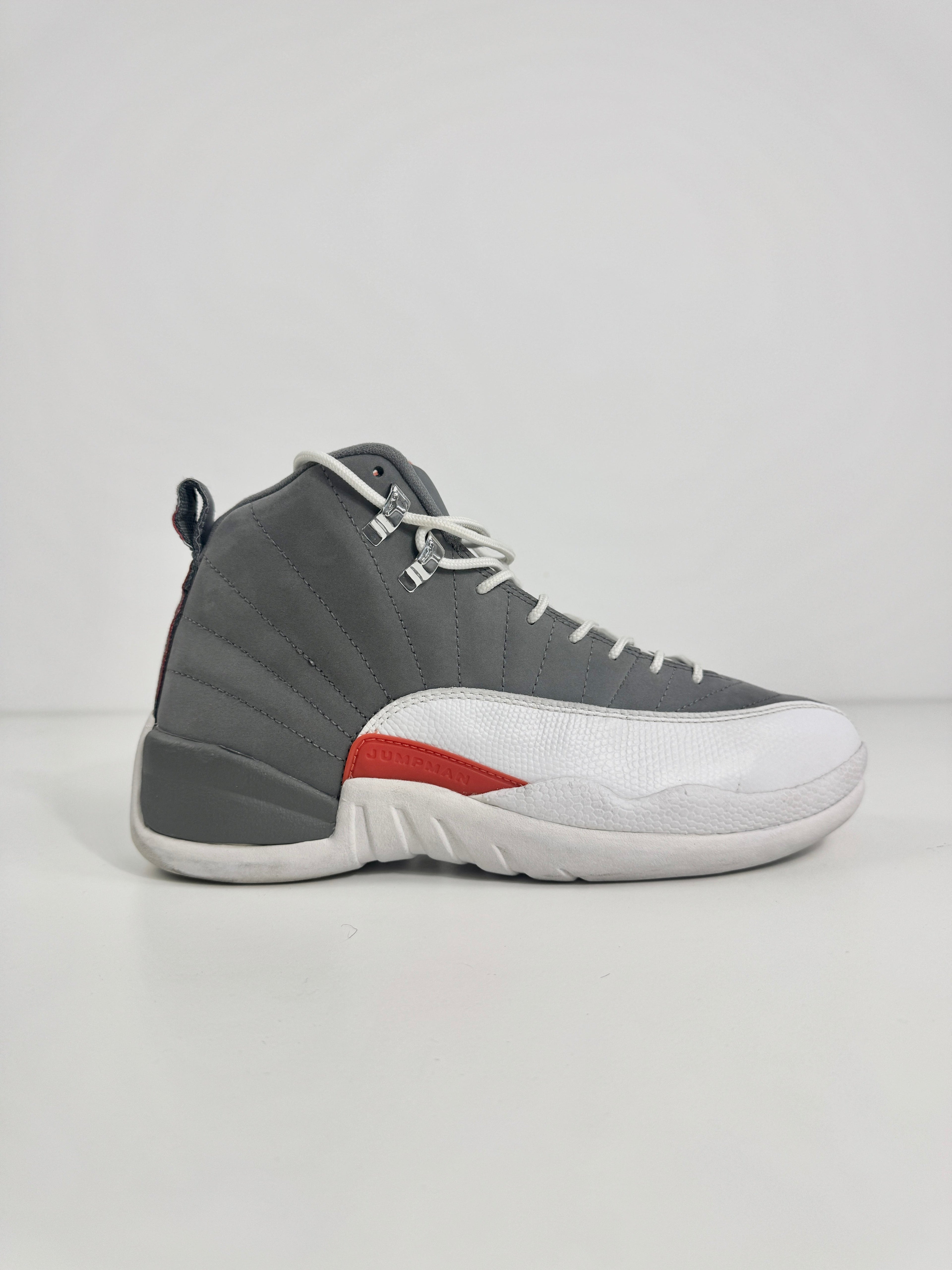 Air Jordan 12 Retro Grey combines a premium grey leather upper with iconic lizard-textured mudguards for a sleek,