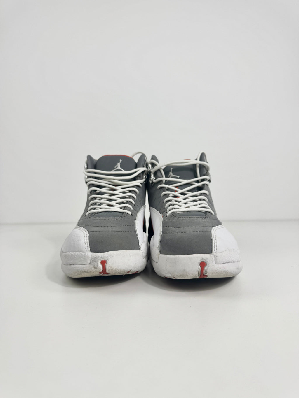 Air Jordan 12 Retro Grey combines a premium grey leather upper with iconic lizard-textured mudguards for a sleek,