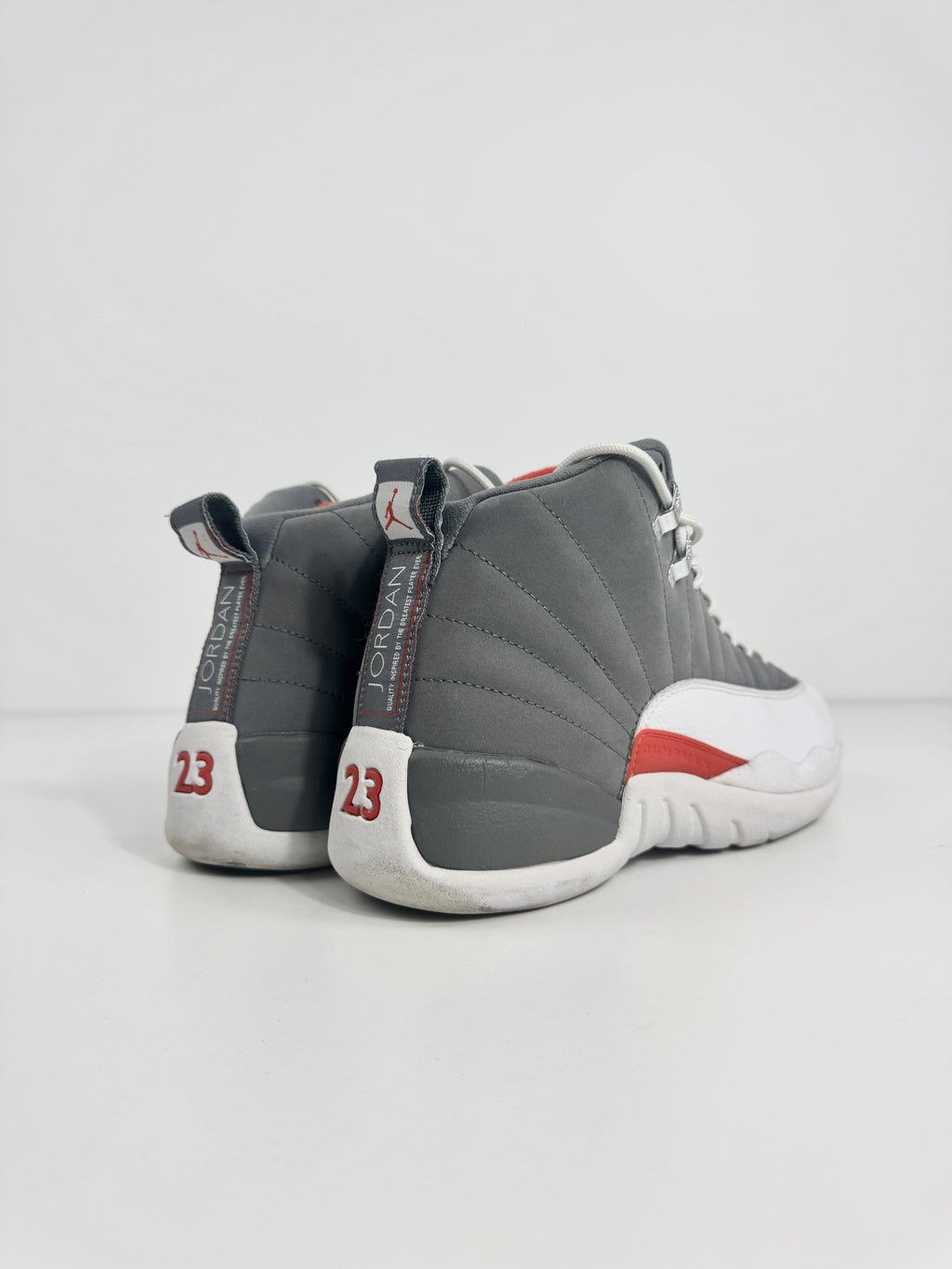 Air Jordan 12 Retro Grey combines a premium grey leather upper with iconic lizard-textured mudguards for a sleek,
