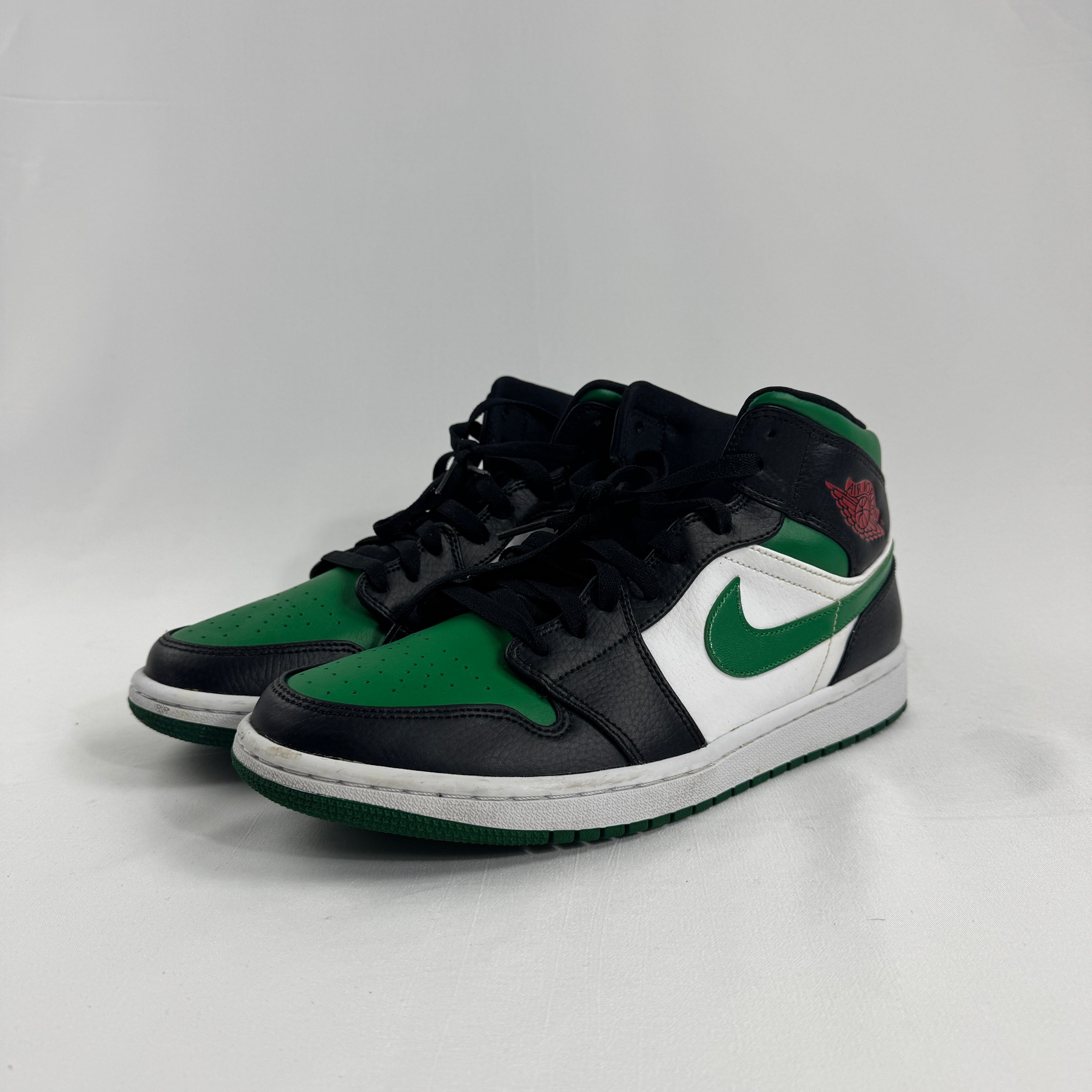 Air Jordan 1 Mid Black/Pine Green is a versatile take on the classic Air Jordan 1 Mid silhouette, featuring a sleek black