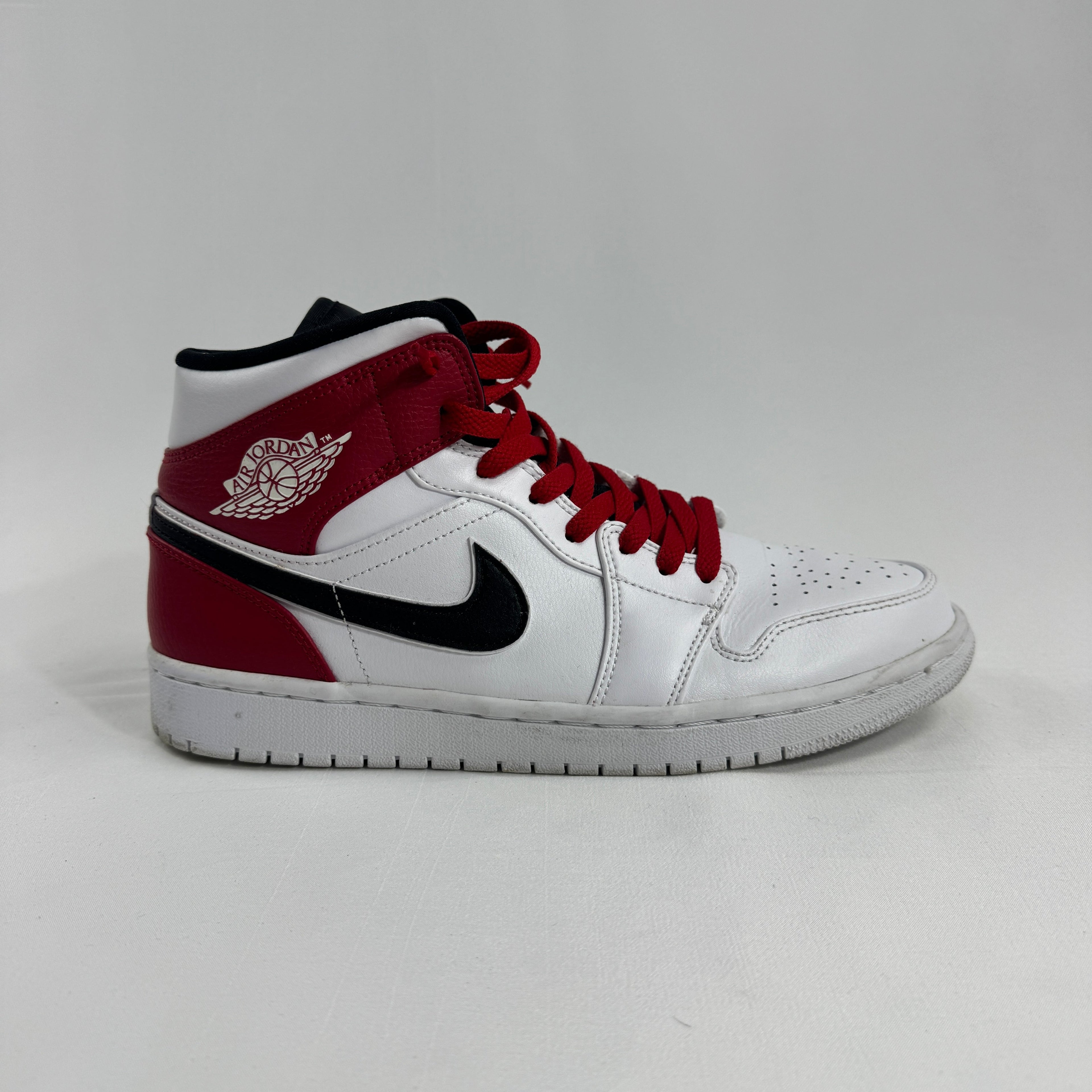 Air Jordan 1 Mid Red/White/Black combines one of the most iconic color palettes in sneaker history with the versatile Air