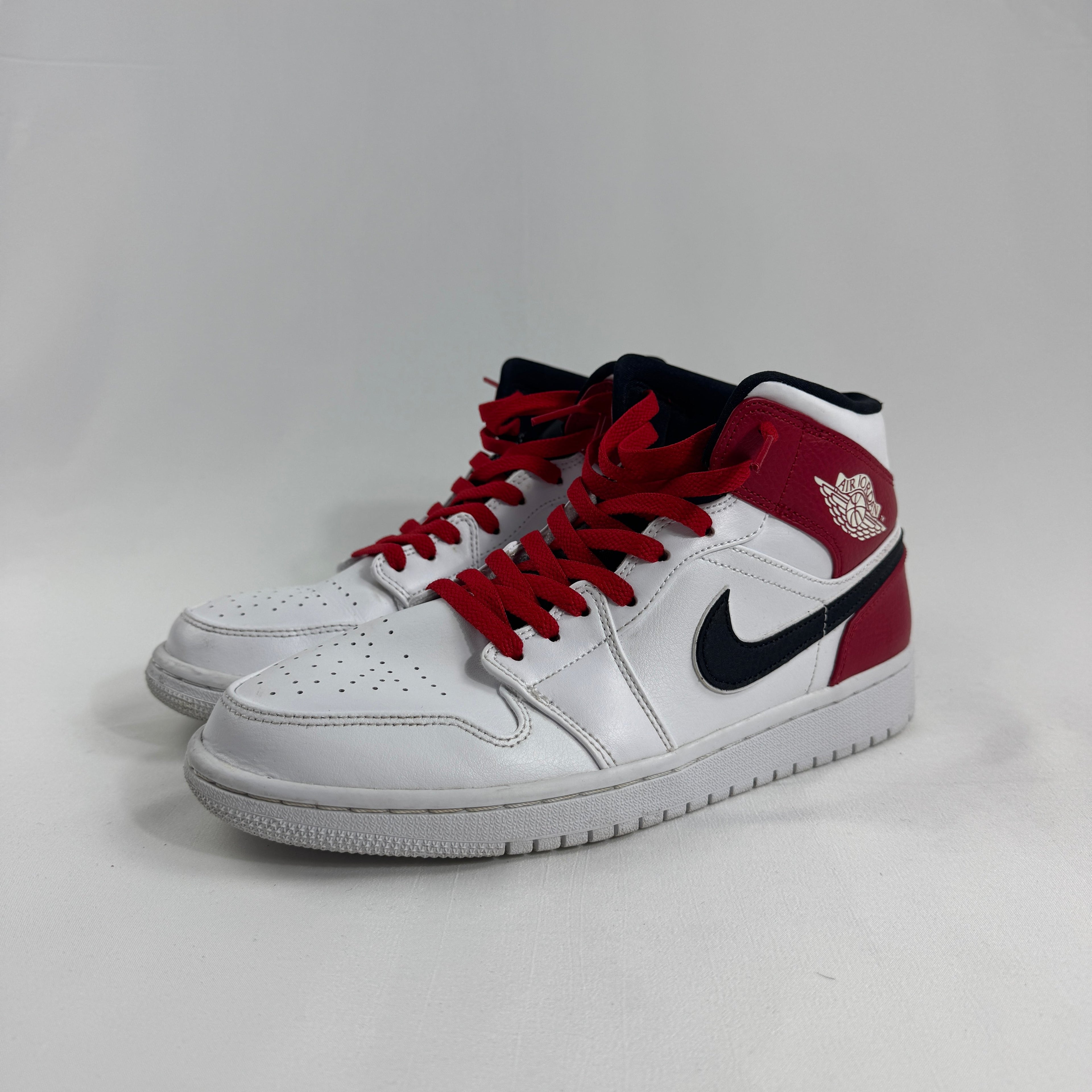 Air Jordan 1 Mid Red/White/Black combines one of the most iconic color palettes in sneaker history with the versatile Air