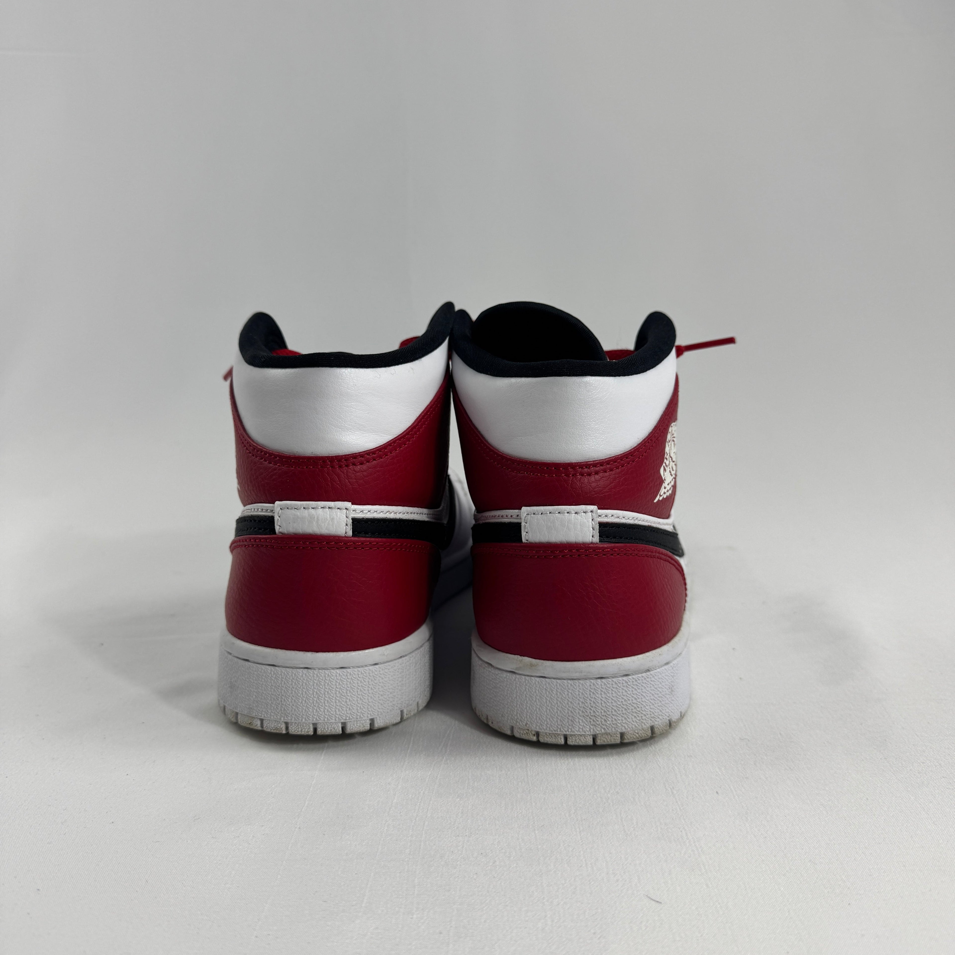Air Jordan 1 Mid Red/White/Black combines one of the most iconic color palettes in sneaker history with the versatile Air