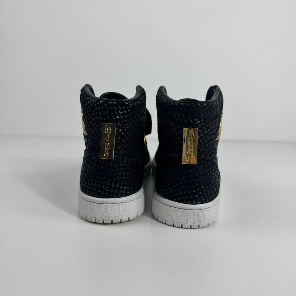 Black textured Nike high-top trainers with white soles and gold MJ23 tags on the heel, displayed against a white background.