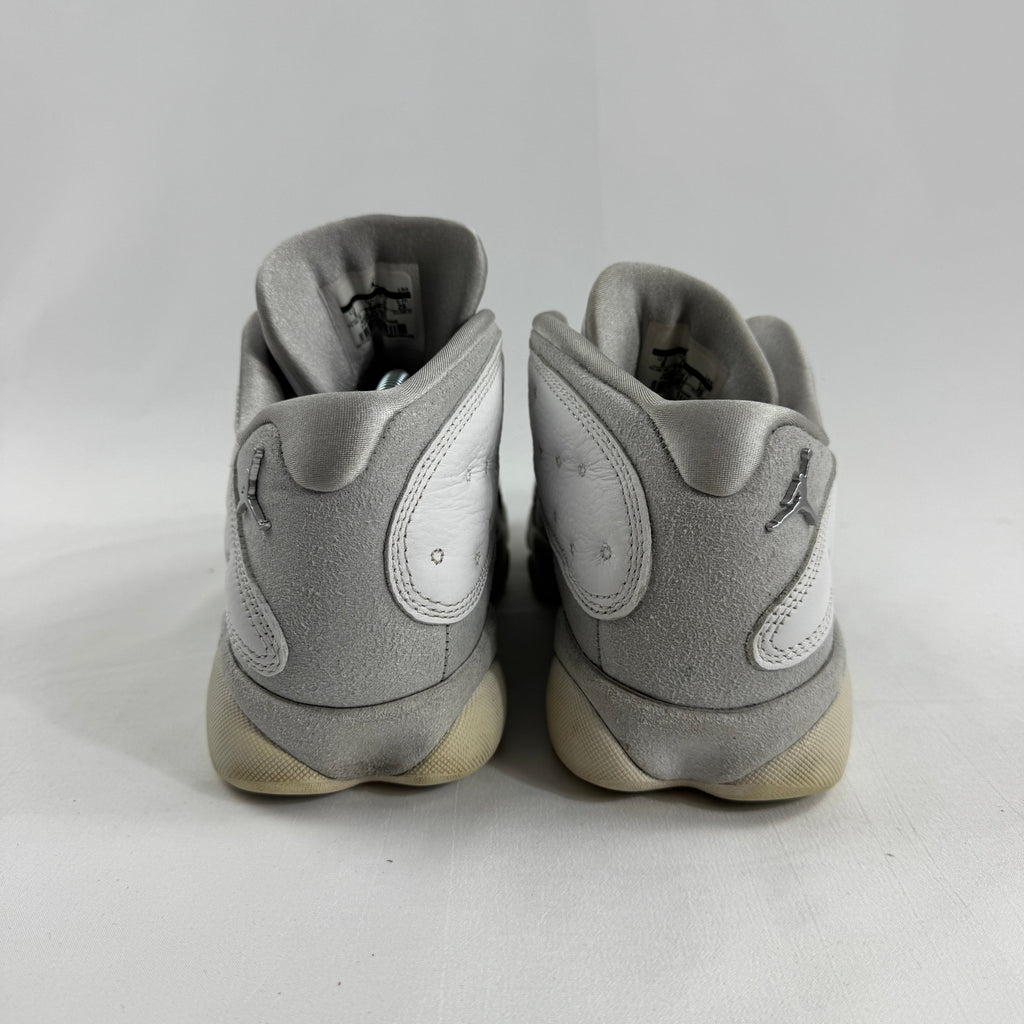 Air Jordan 1 Retro Low “Pure Platinum” is a clean low-top sneaker in mostly white leather with light grey detailing, giving