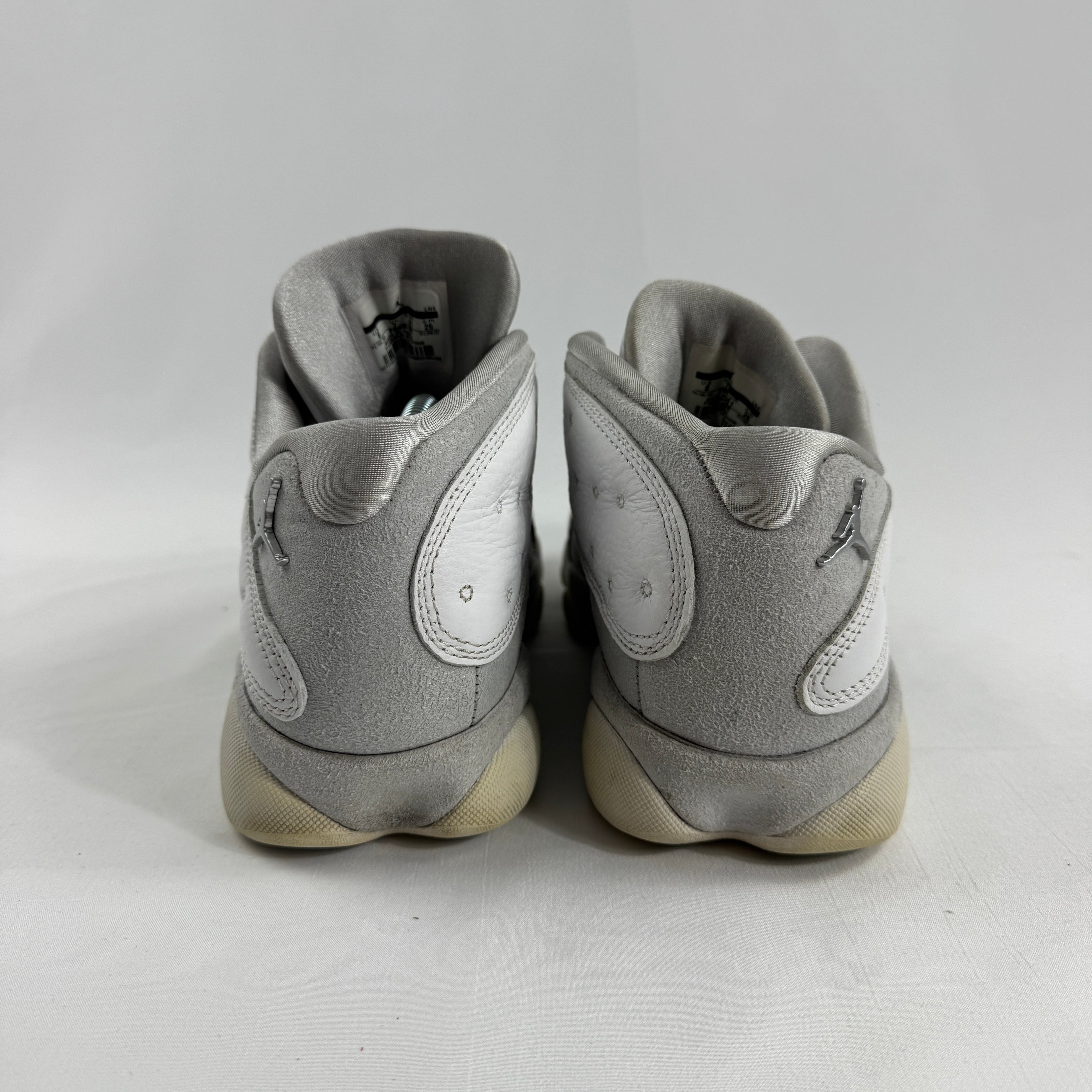 Air Jordan 1 Retro Low “Pure Platinum” is a clean low-top sneaker in mostly white leather with light grey detailing, giving