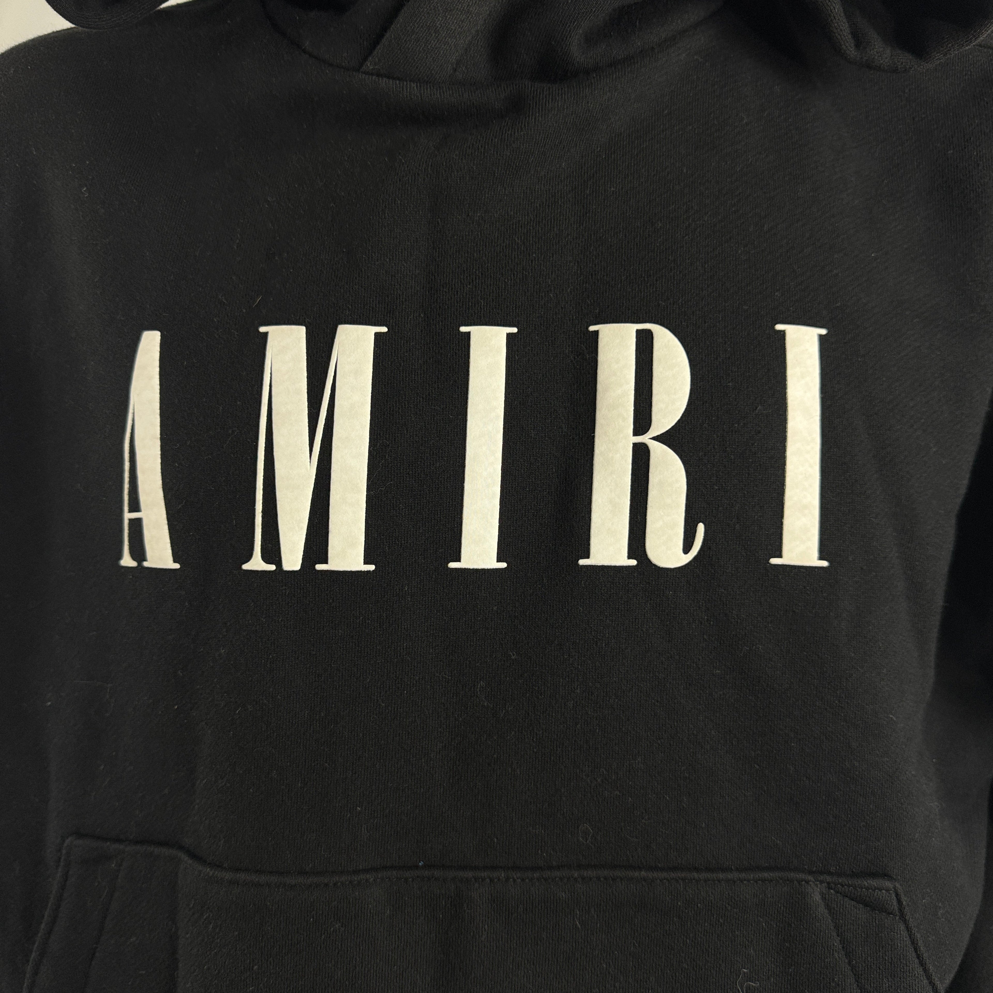 Amiri Black Logo Hoodie crafted from premium cotton, featuring the signature Amiri logo, ribbed trims, and a relaxed fit for