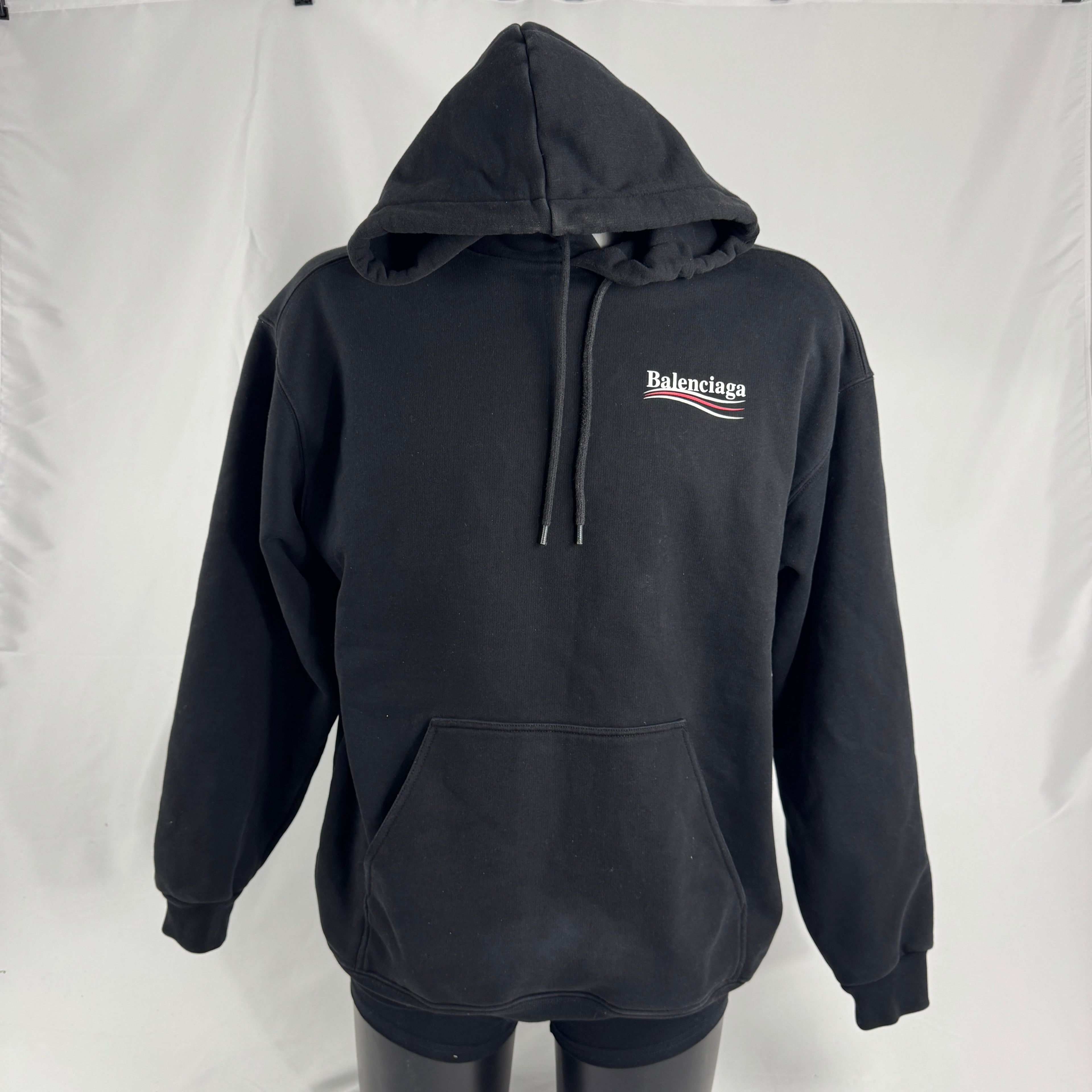 The Balenciaga Political Campaign Hoodie is a heavyweight cotton hoodie featuring the brand’s satirical “campaign” logo
