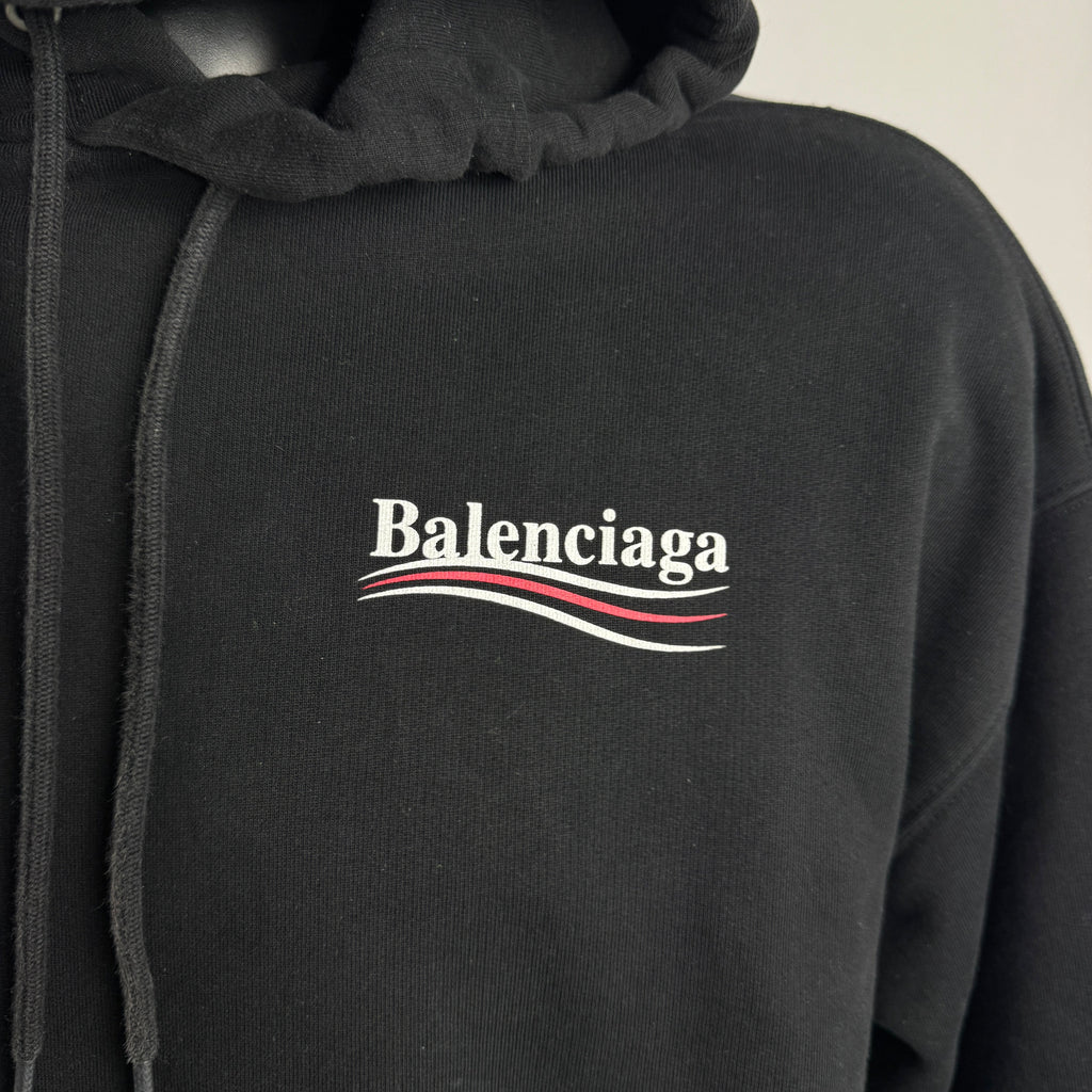 The Balenciaga Political Campaign Hoodie is a heavyweight cotton hoodie featuring the brand’s satirical “campaign” logo