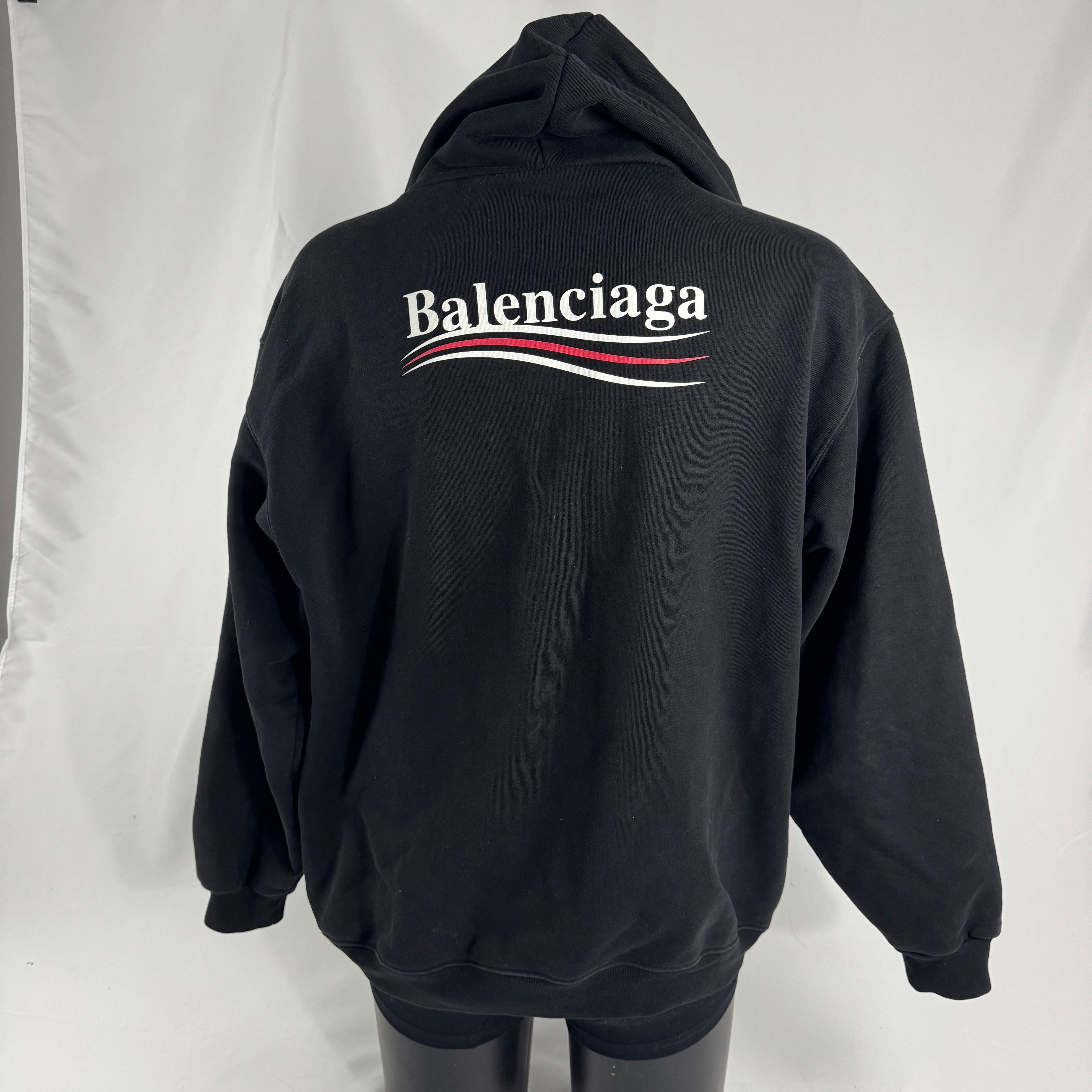 The Balenciaga Political Campaign Hoodie is a heavyweight cotton hoodie featuring the brand’s satirical “campaign” logo