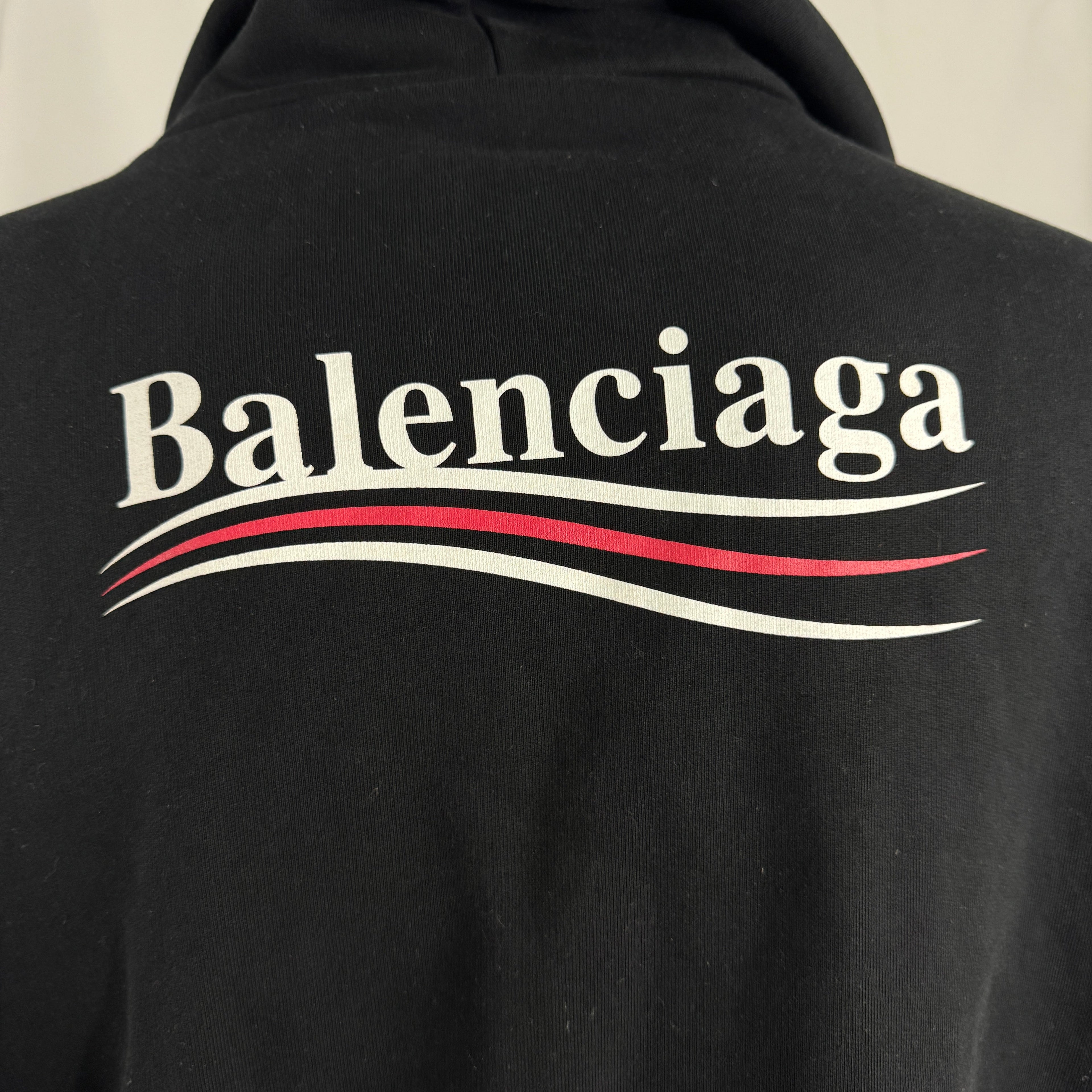The Balenciaga Political Campaign Hoodie is a heavyweight cotton hoodie featuring the brand’s satirical “campaign” logo