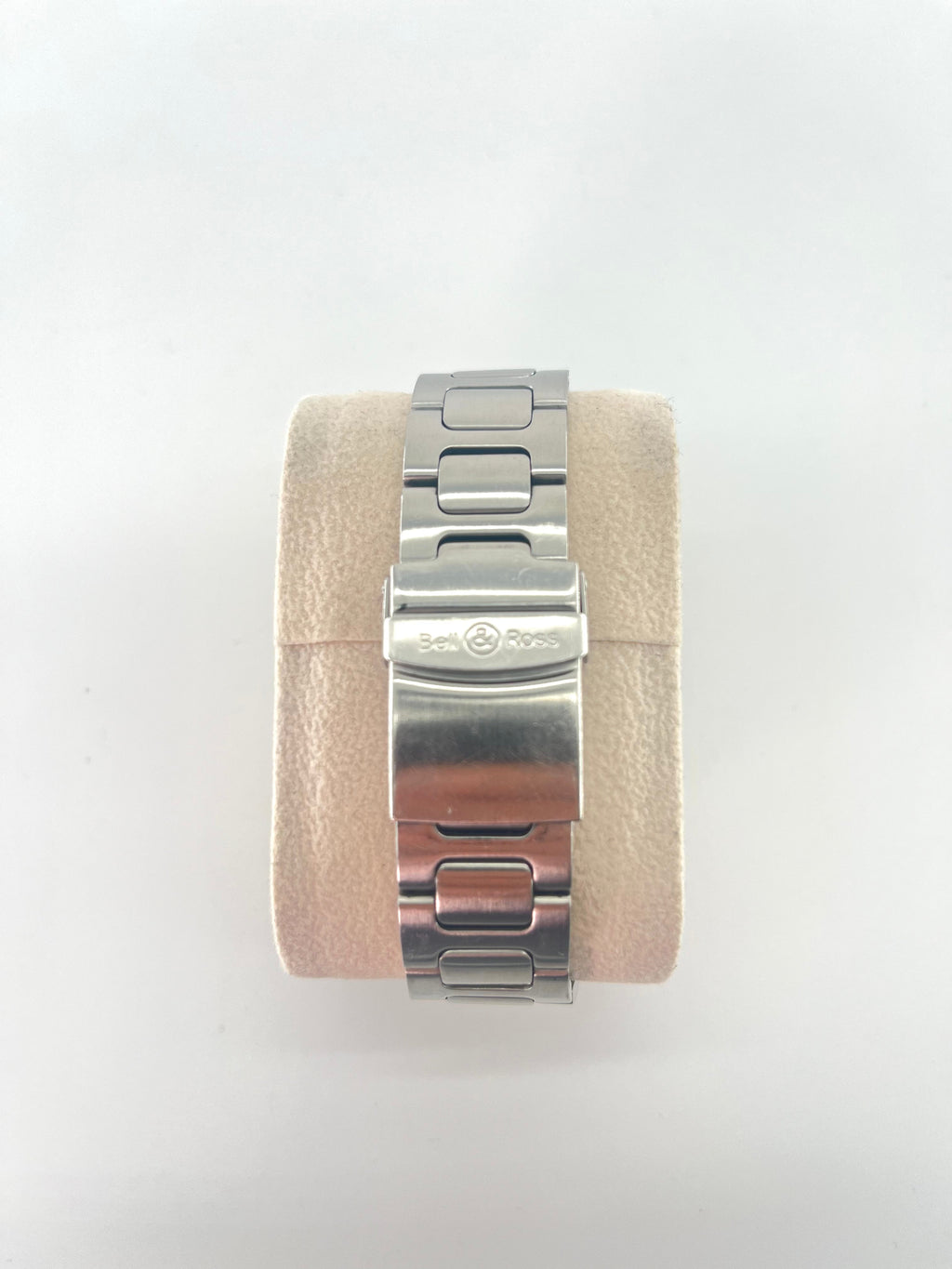 Bell and Ross Hydromax 2010 stainless steel watch bracelet on a beige velvet cushion, shown with extra watch straps on white background.