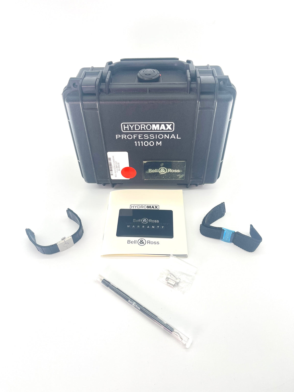 Bell & Ross watch with logo, a manual, warranty card, two spare straps, a parts bag and tool displayed on a white background.