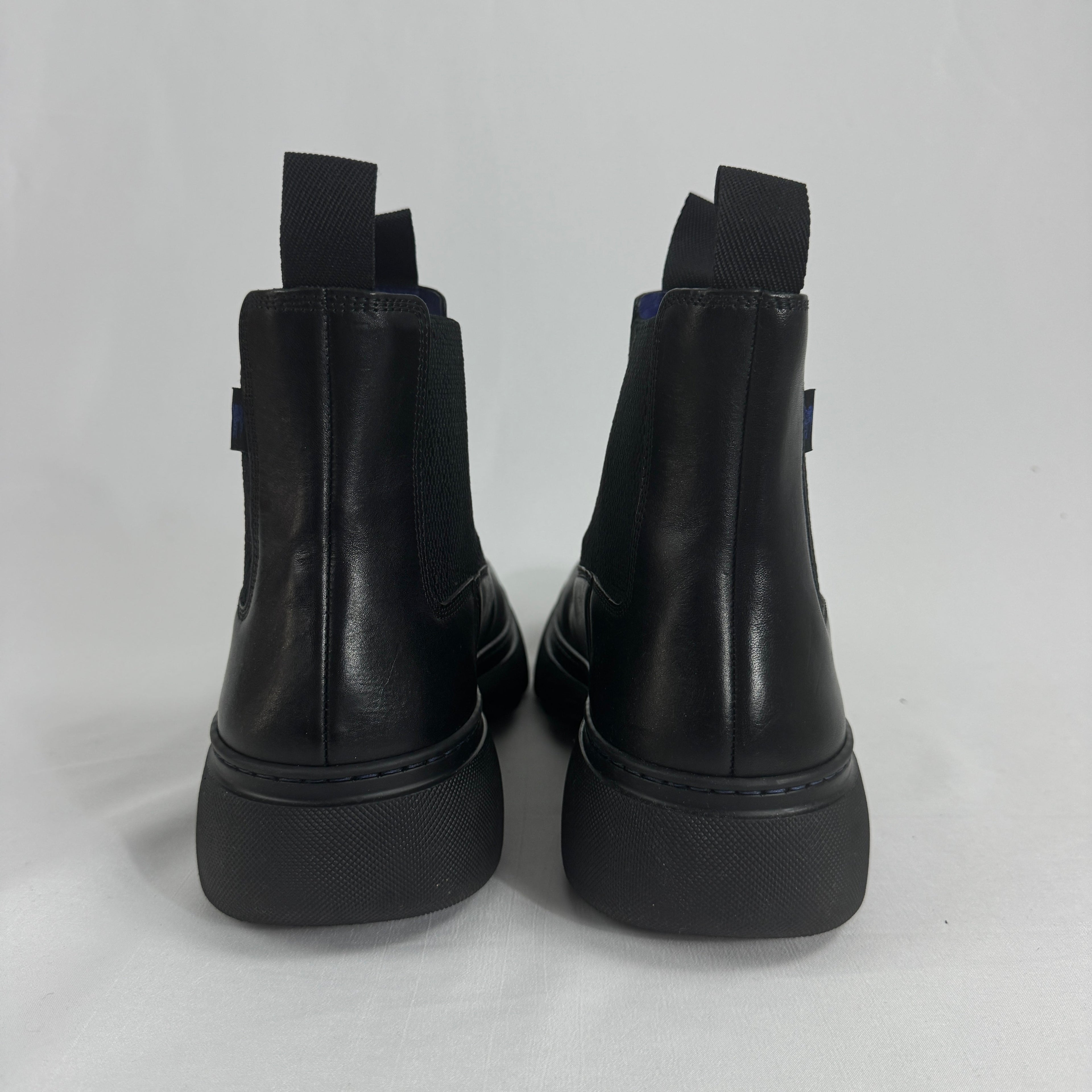 The Burberry Creeper Chelsea Low is a modern take on the classic Chelsea boot, blending sleek British tailoring with a