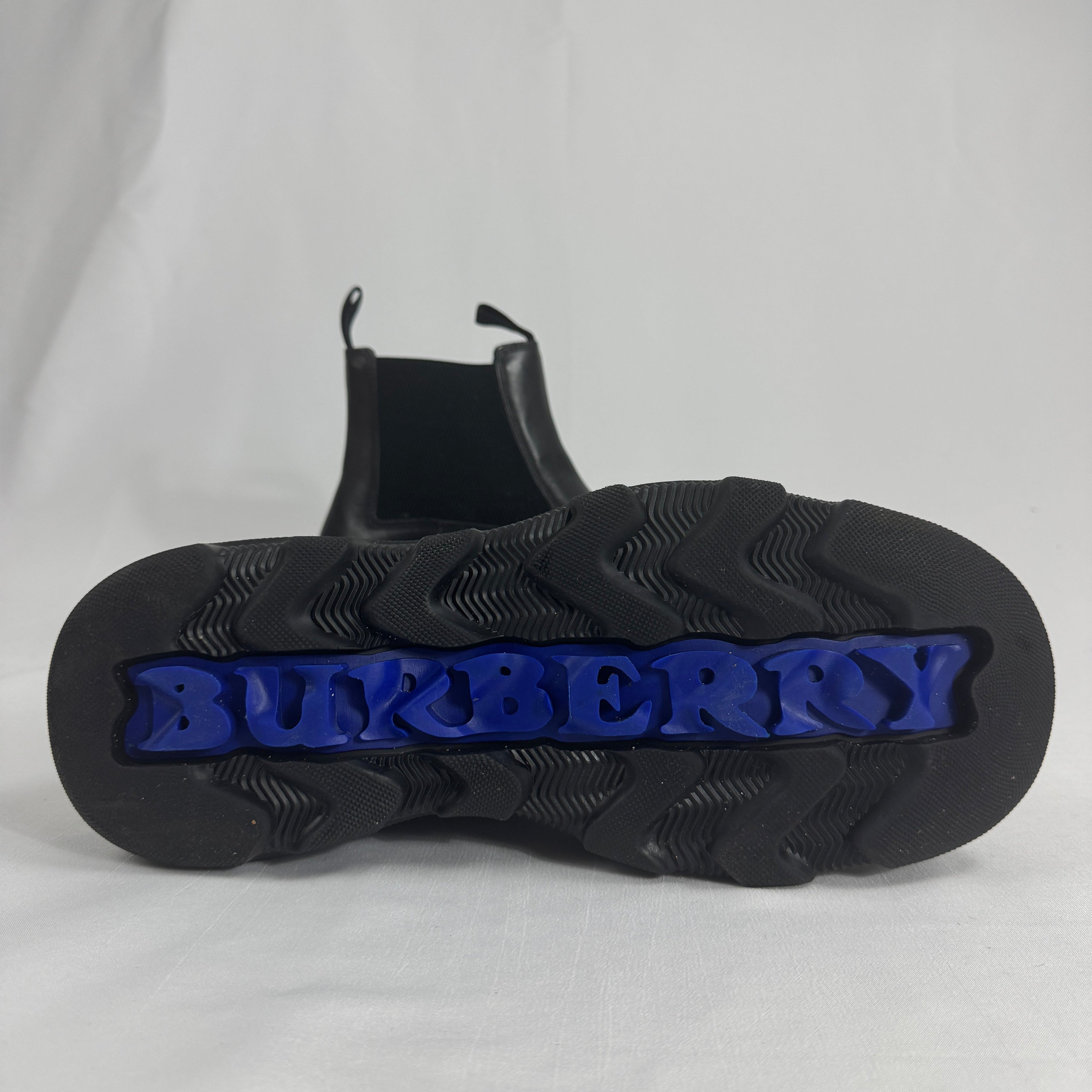 The Burberry Creeper Chelsea Low is a modern take on the classic Chelsea boot, blending sleek British tailoring with a