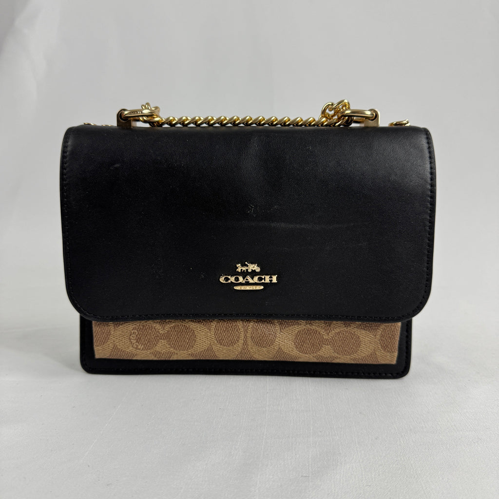 The Coach Klare Crossbody Bag is a structured leather bag with a flap closure, signature hardware, and an adjustable strap,