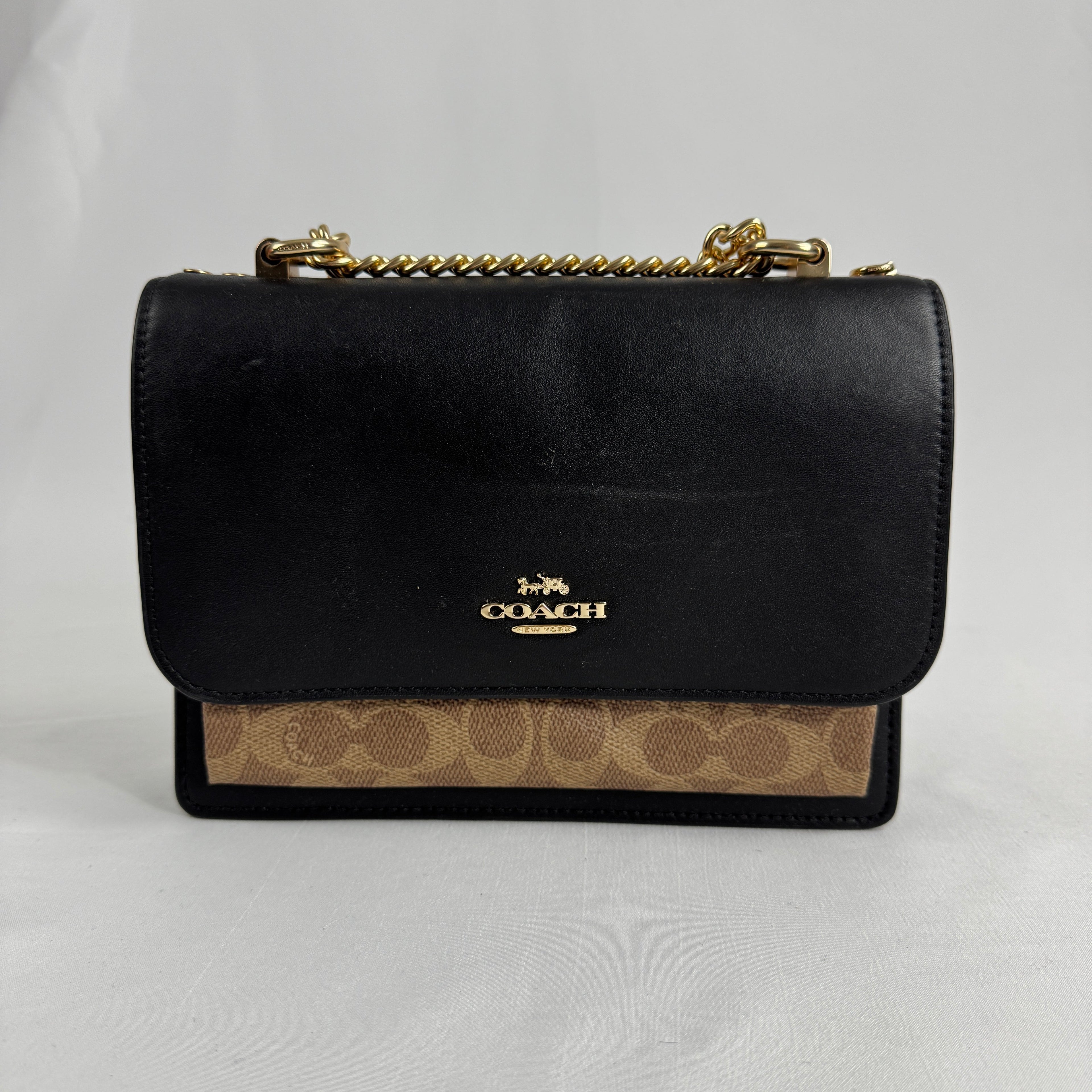 The Coach Klare Crossbody Bag is a structured leather bag with a flap closure, signature hardware, and an adjustable strap,